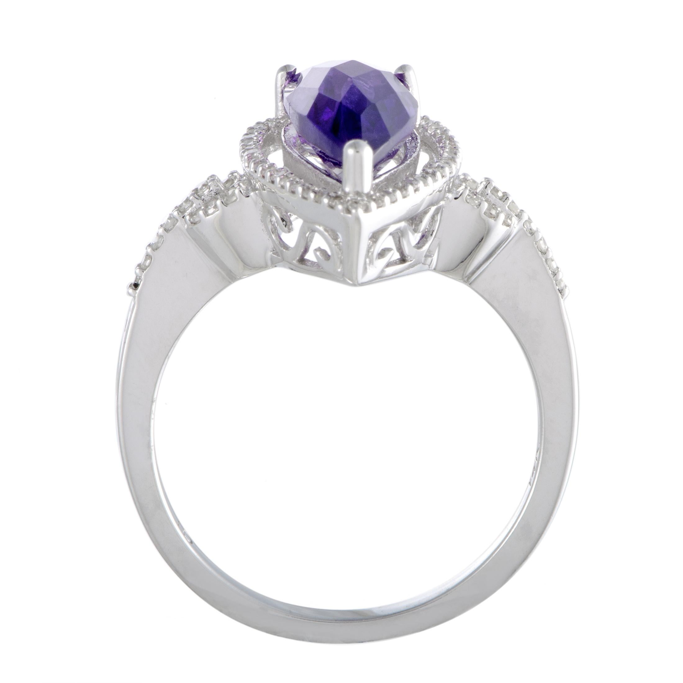 This remarkable 14K white gold ring is exceptionally sublime! The beautifully unique design is adorned in 0.21ct of sparkling diamonds and a magnificent amethyst that perfectly epitomize elegance and class.
 Ring Top Dimensions: 18mm x 20mm