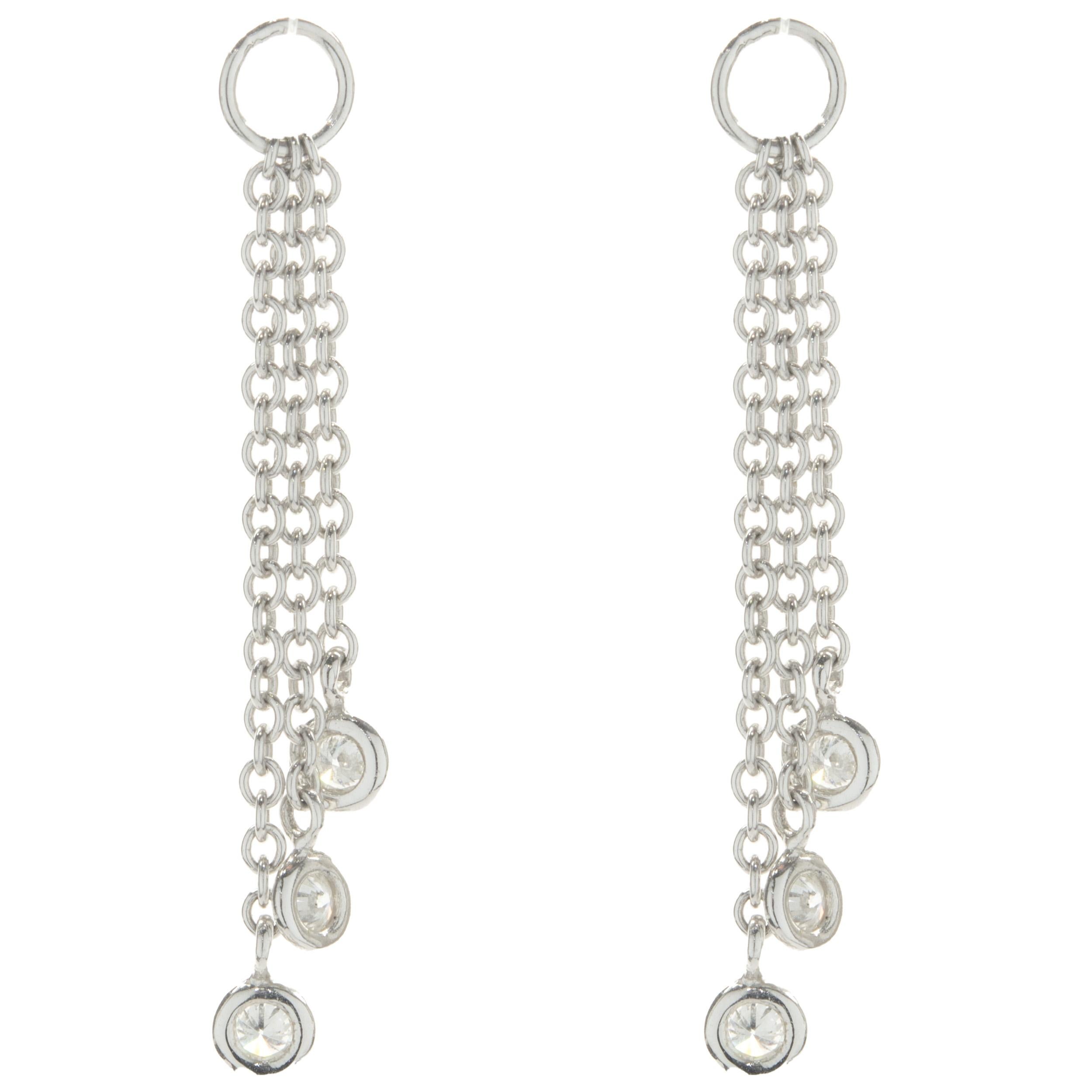 Designer: custom design
Material: 14K white gold
Diamonds: 6 round brilliant cut = 0.36cttw
Color: G
Clarity: SI1
Dimensions: earrings measure 34mm in length
Weight: 1.56 grams