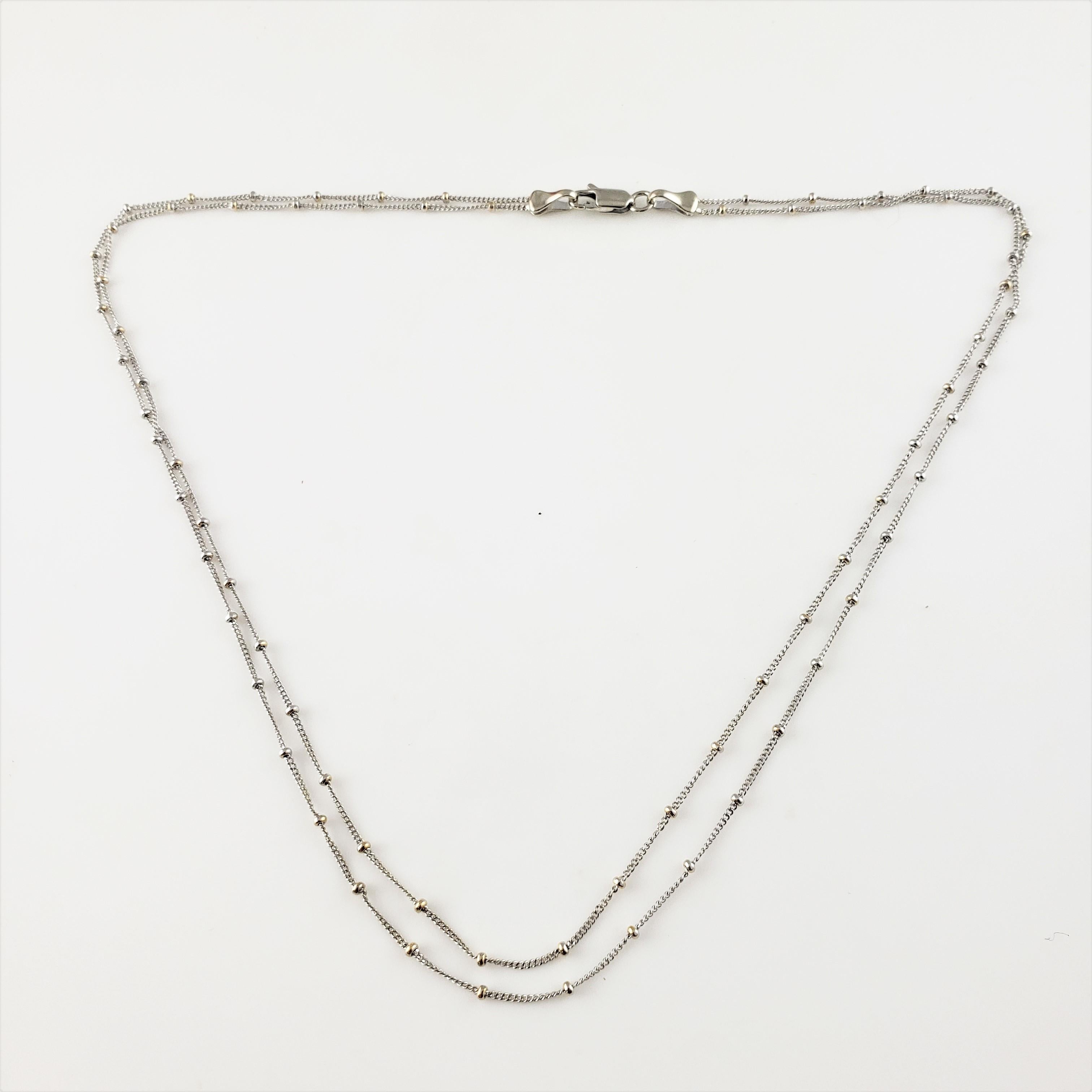 Vintage 14 Karat White Gold Double Strand Necklace-

This elegant double strand beaded chain necklace is crafted in beautifully detailed 14K white gold.

Size: 16 inches

Weight: 2.7 dwt. / 4.3 gr.

Stamped: 585