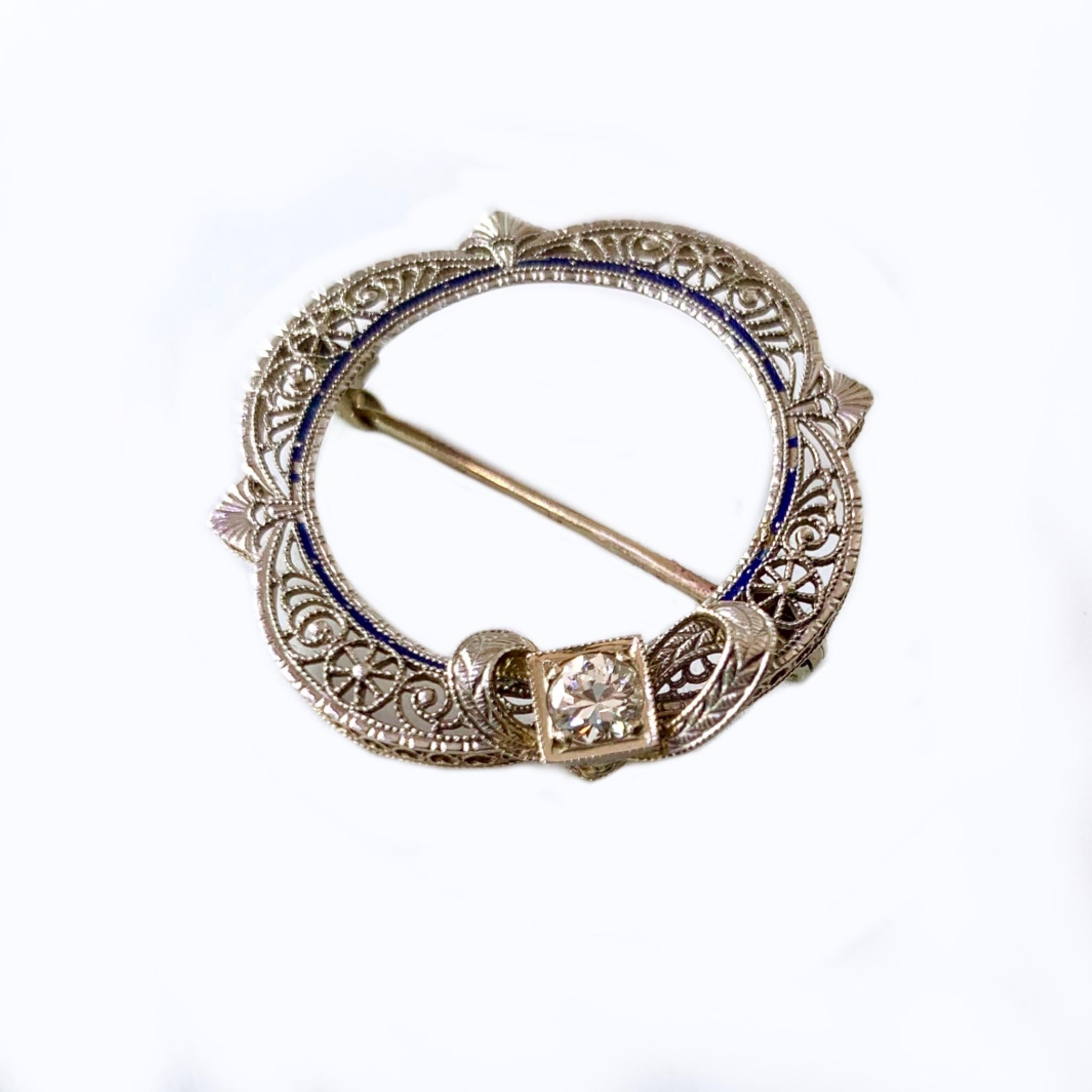 14 karat white gold vintage filigree brooch containing a beautiful .25 carat diamond. 