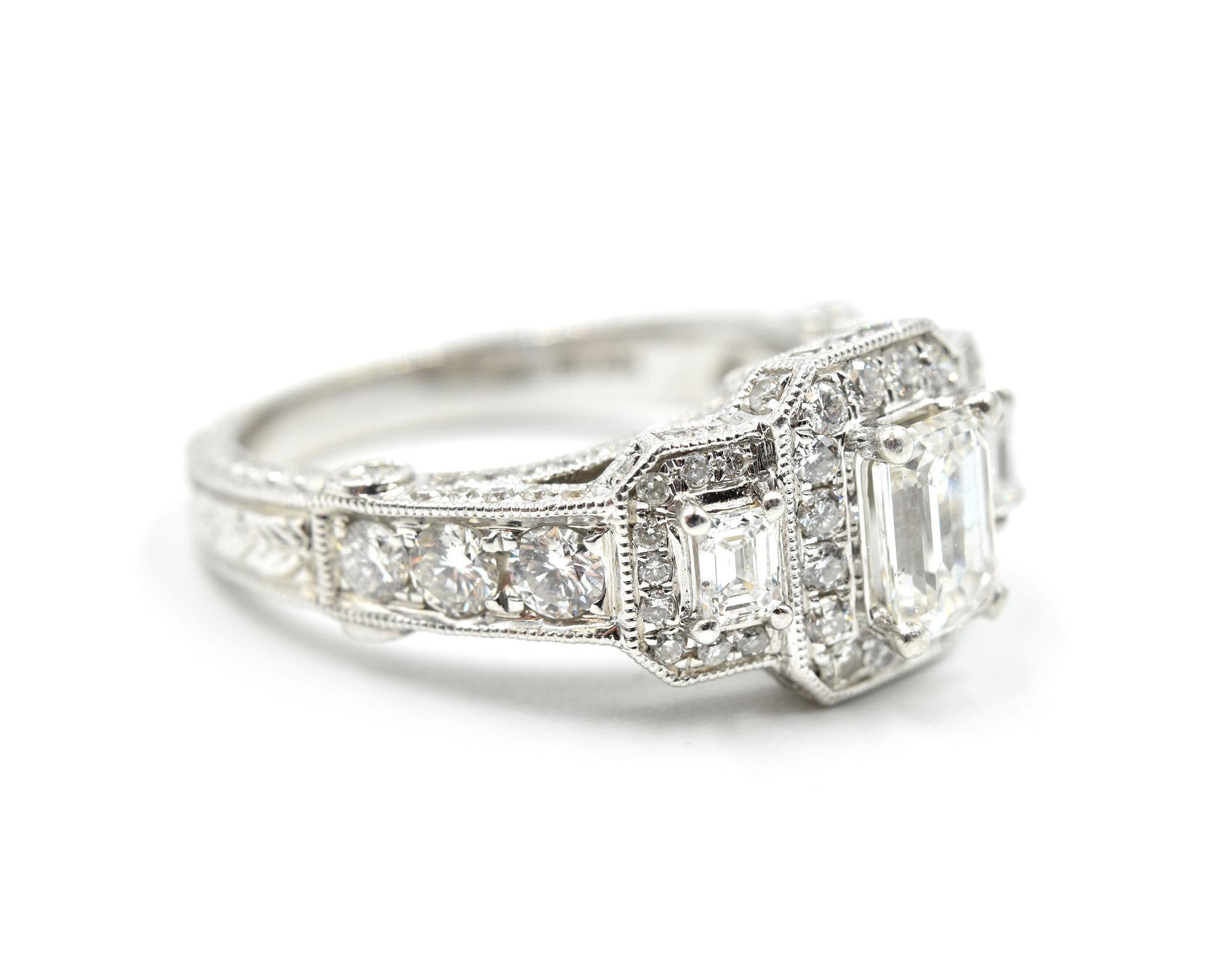 This beautiful engagement ring features a gleaming array of 3 emerald cut diamonds weighing approximately .90cttw and 120 round brilliant cut diamonds weighing approximately 1.45cttw. The diamonds are graded H in color and I1 in clarity. The
