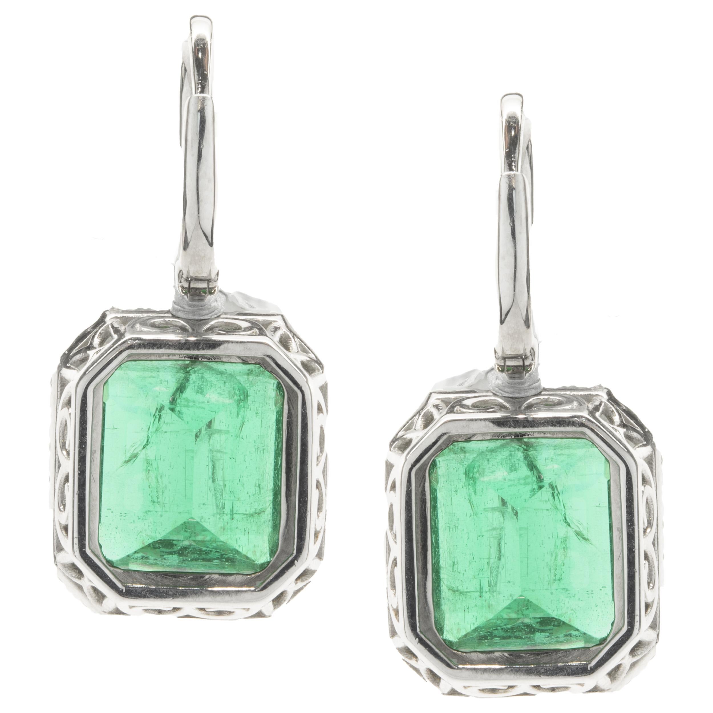 Designer: custom
Material: 14K white gold
Diamond: 72 round brilliant cut = 0.95cttw
Color: F
Clarity: VS1-2
Emerald: 2 emerald cut = 13.92cttw
Dimensions: earrings measure 27mm in length 
Fastenings: snap backs
Weight: 8.81 grams