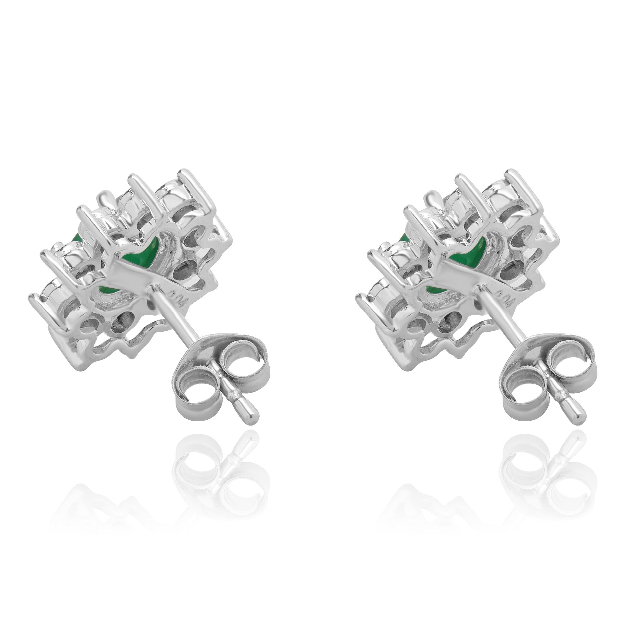 Oval Cut 14 Karat White Gold Emerald and Diamond Halo Stud Earrings For Sale