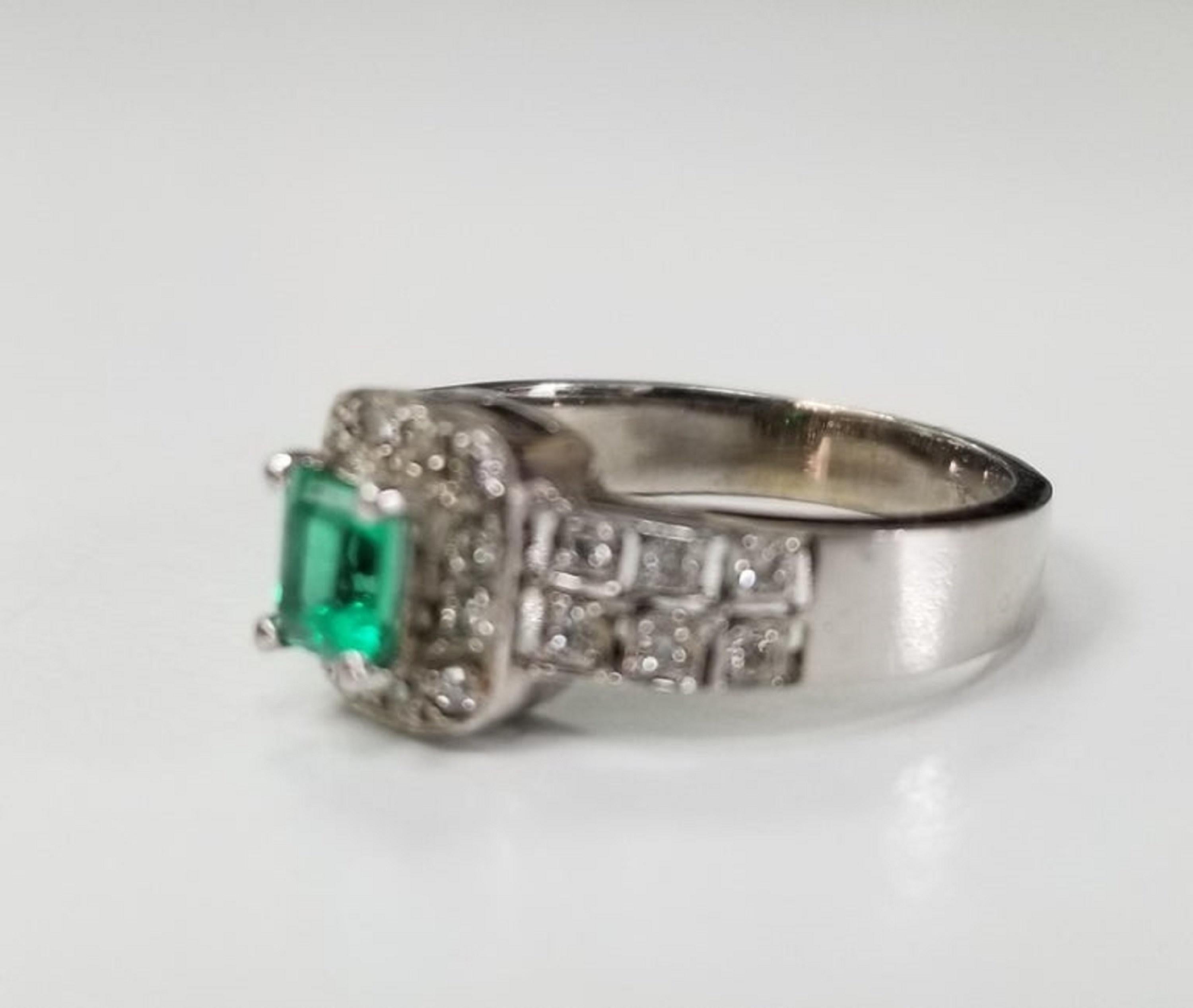 14k white gold emerald and diamond ring, containing 1 emerald cut emerald weighing .38cts. and 26 round full cut diamonds of very fine quality weighing .30pts.