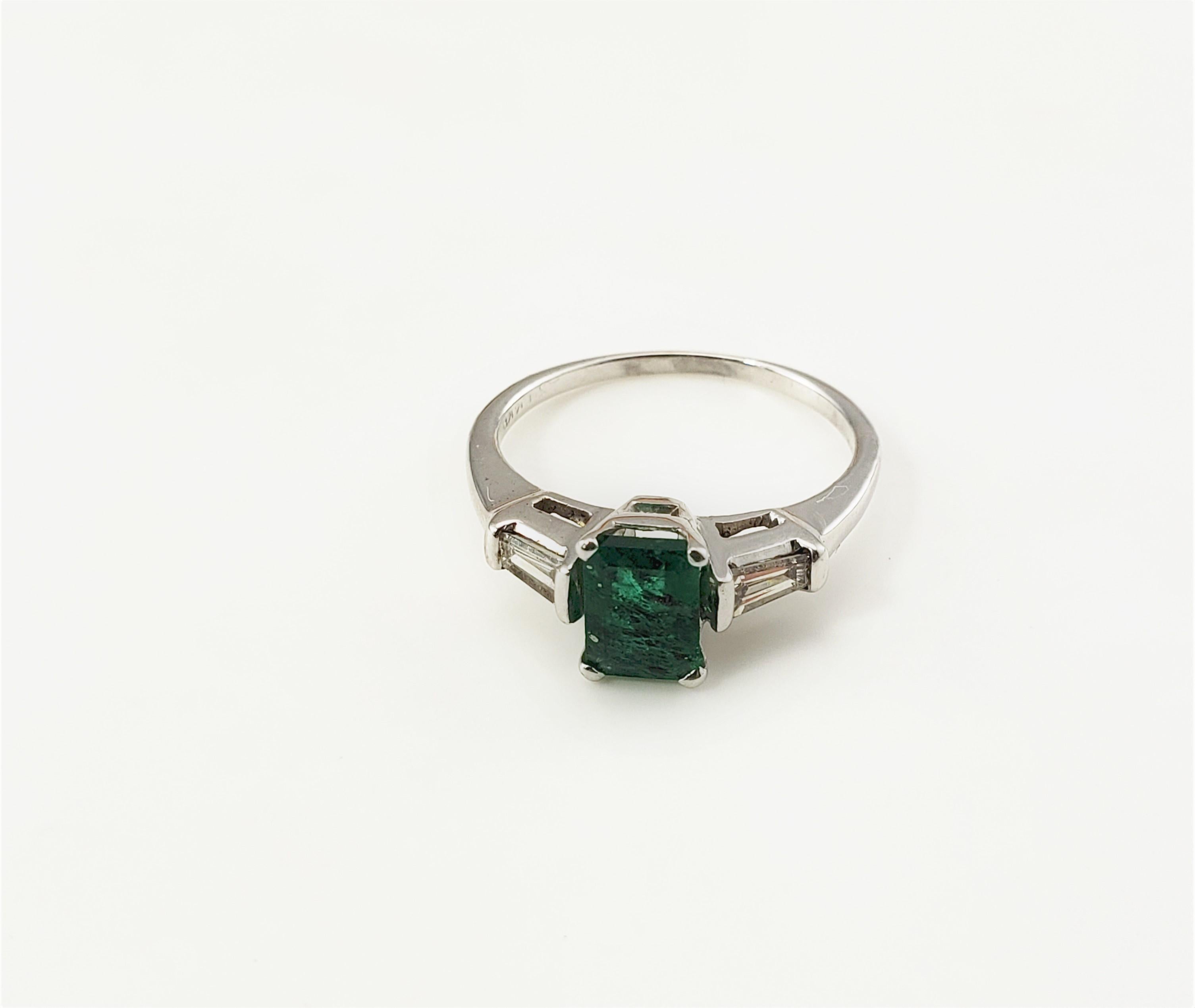 14 Karat White Emerald and Diamond Ring Size 6.25-

This lovely ring features one emerald cut green emerald (7 mm x 5 mm) and two baguette diamonds set in classic 14K white gold.  Shank: 1 mm

Emerald weight:  .91 ct.

Total diamond weight:  .30