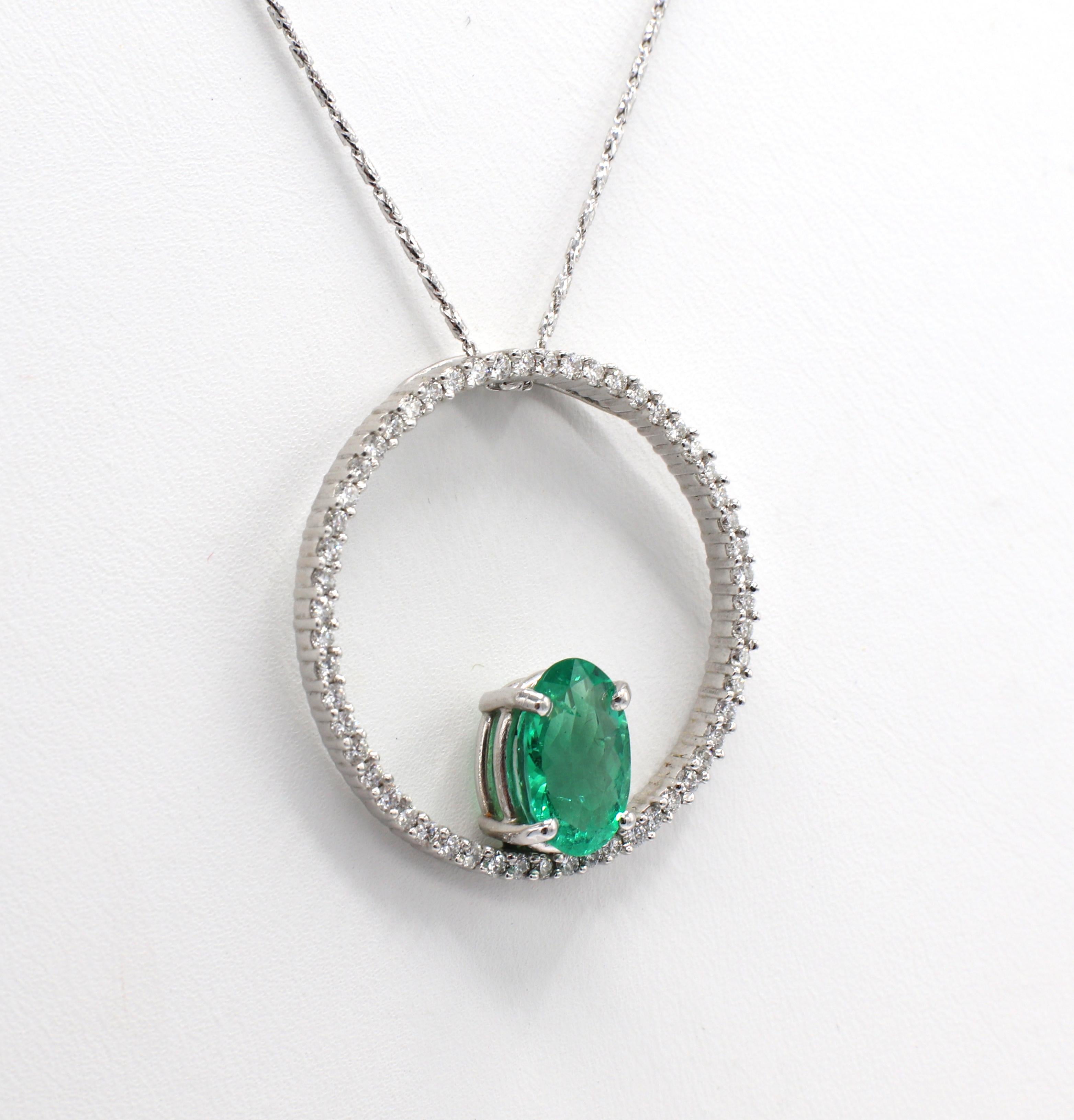 14 Karat White Gold Emerald & Natural Diamond Circle Pendant Drop Necklace
Metal: 14k white gold
Weight: 7.13 grams
Diamonds: Approx. .75 CTW G VS natural diamonds
Emerald: Approx. 2 carats, oval shape
Chain length: 18 inches
Pendant: 30mm