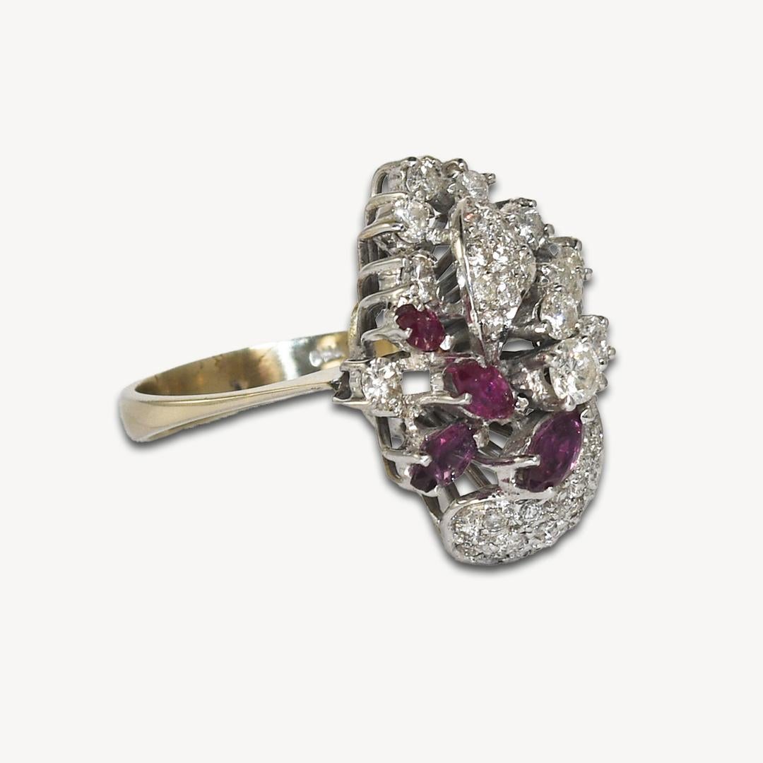 Estate ring with Diamonds and Rubies in 18k white gold.
Marked .750 and weighs 8.2 grams.
The diamonds are round brilliant cuts, 1.00 total carat weight, h to i color, si clarity.
The largest Diamond is 0.20 carats.
On the sides are Marquise shaped