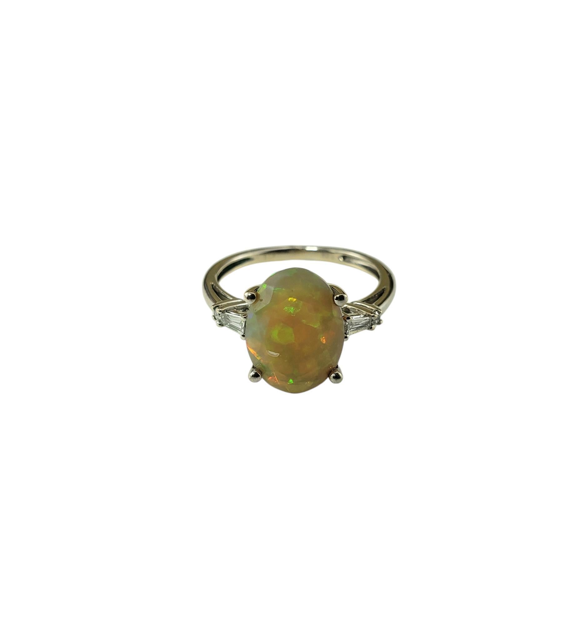14 Karat White Gold Faceted Opal and Diamond Ring Size 6.5 JAGi Certified-

This elegant ring features one oval faceted opal* (12.2 m x 8.7 mm), two baguette diamonds and two round brilliant cut diamonds set in 14K white gold. Shank: 2 mm.

*Small