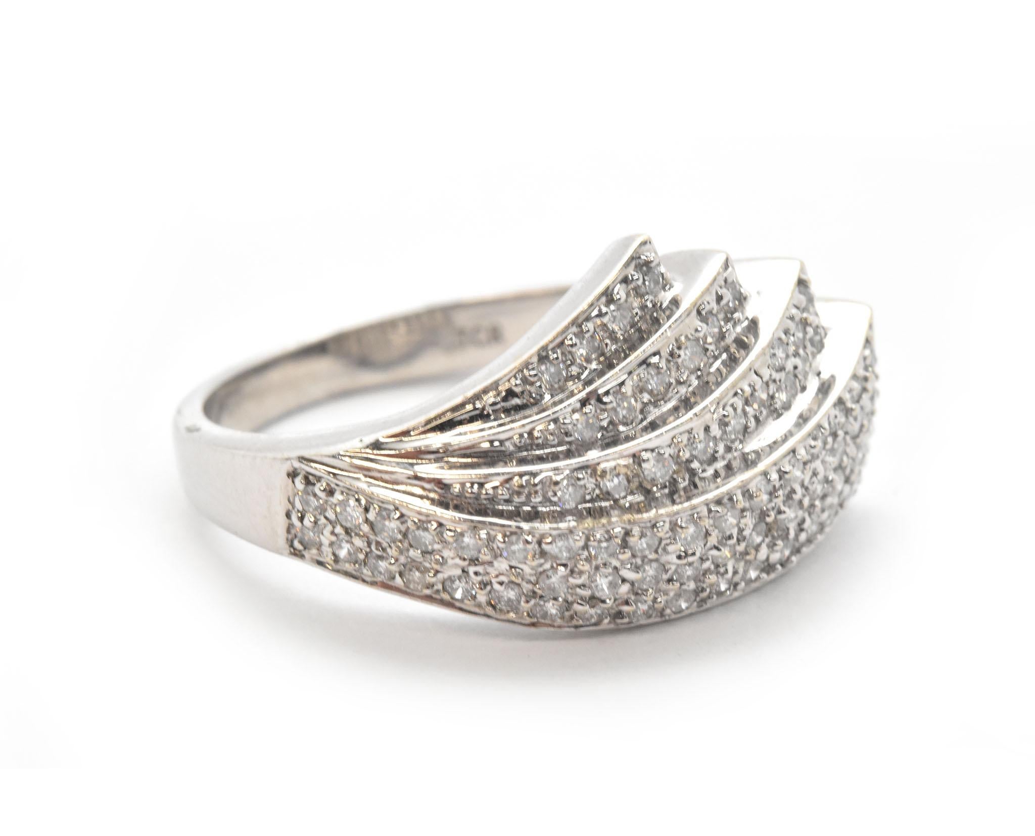 This fanning diamond band ring is made in 14k white gold and set with a total of 0.75 carats of white diamonds. Diamonds on this band ring are individually prong set to best display their true beauty, diamonds are graded I in color and SI1 in