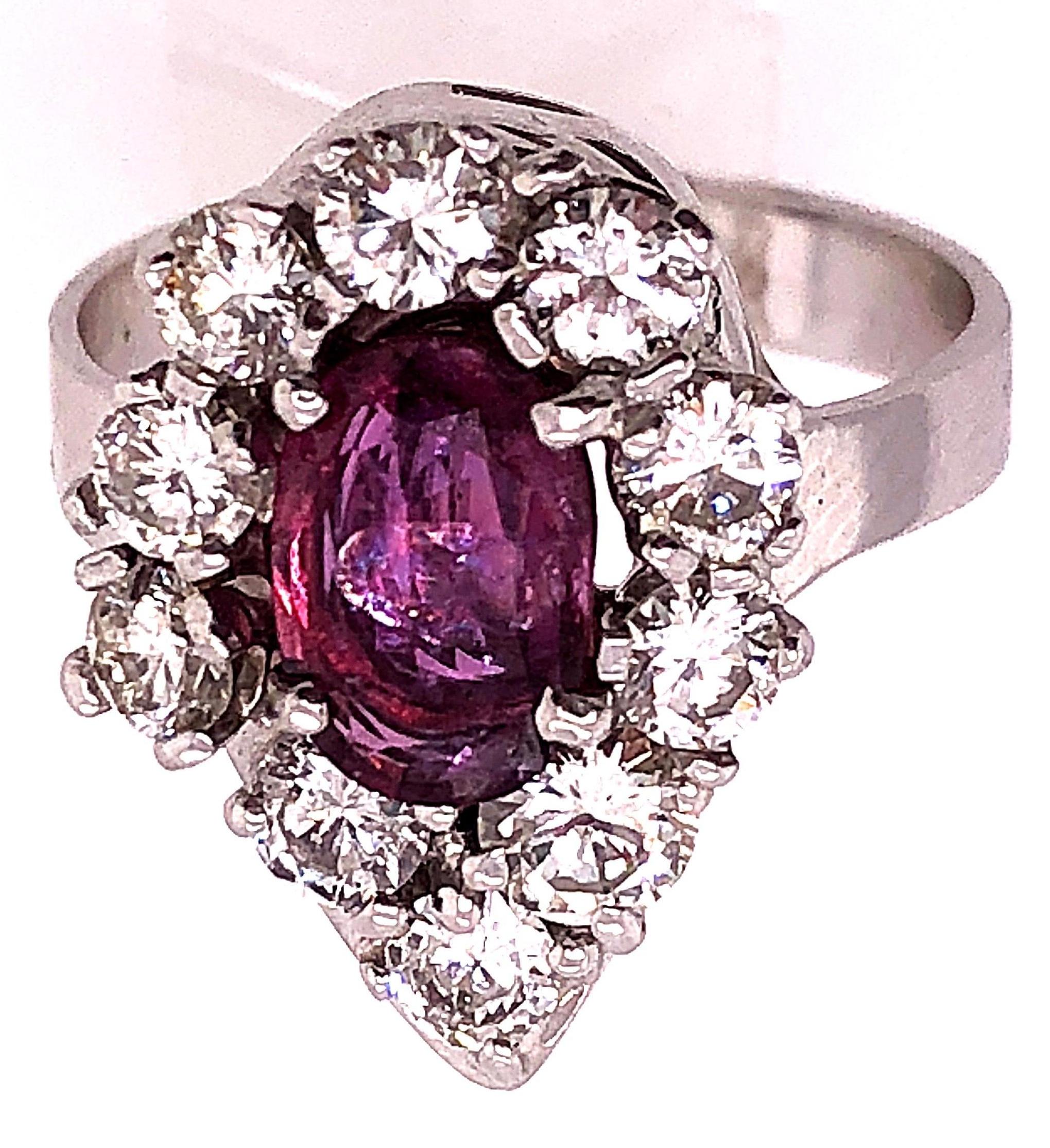 14 Karat White Gold Fashion Oval Ruby Ring with Round Diamonds.
1.50 total diamond weight.
1.25 total ruby weight
Size 7.25
Height: 20 mm
Width: 14 mm 
6.21 grams total weight.
