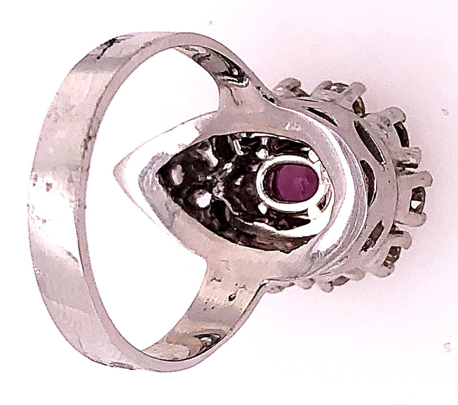 Women's or Men's 14 Karat White Gold Fashion Oval Ruby Solitaire Ring with Encircling Diamonds For Sale