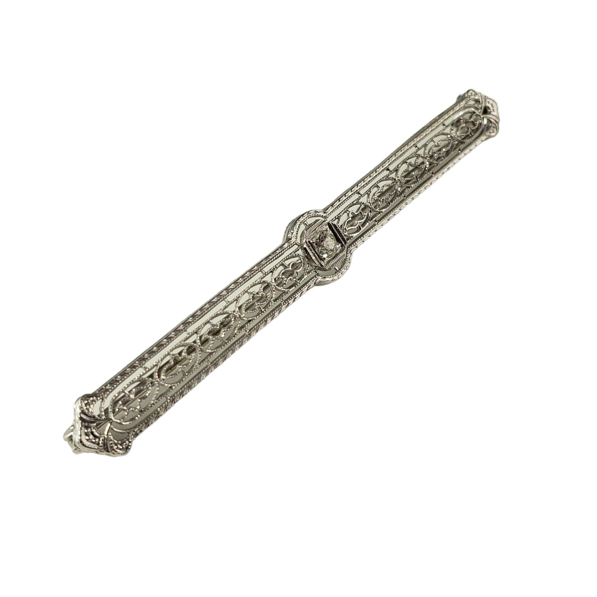 This elegant bar pin features one round brilliant cut diamond set in beautifully detailed 14K white gold filigree.  Width: 5 mm

Approximate diamond weight: .13 ct.

Diamond color: K

Diamond clarity: VS2

Size:  2.5 inches

Weight:  3.7 gr./  2.3