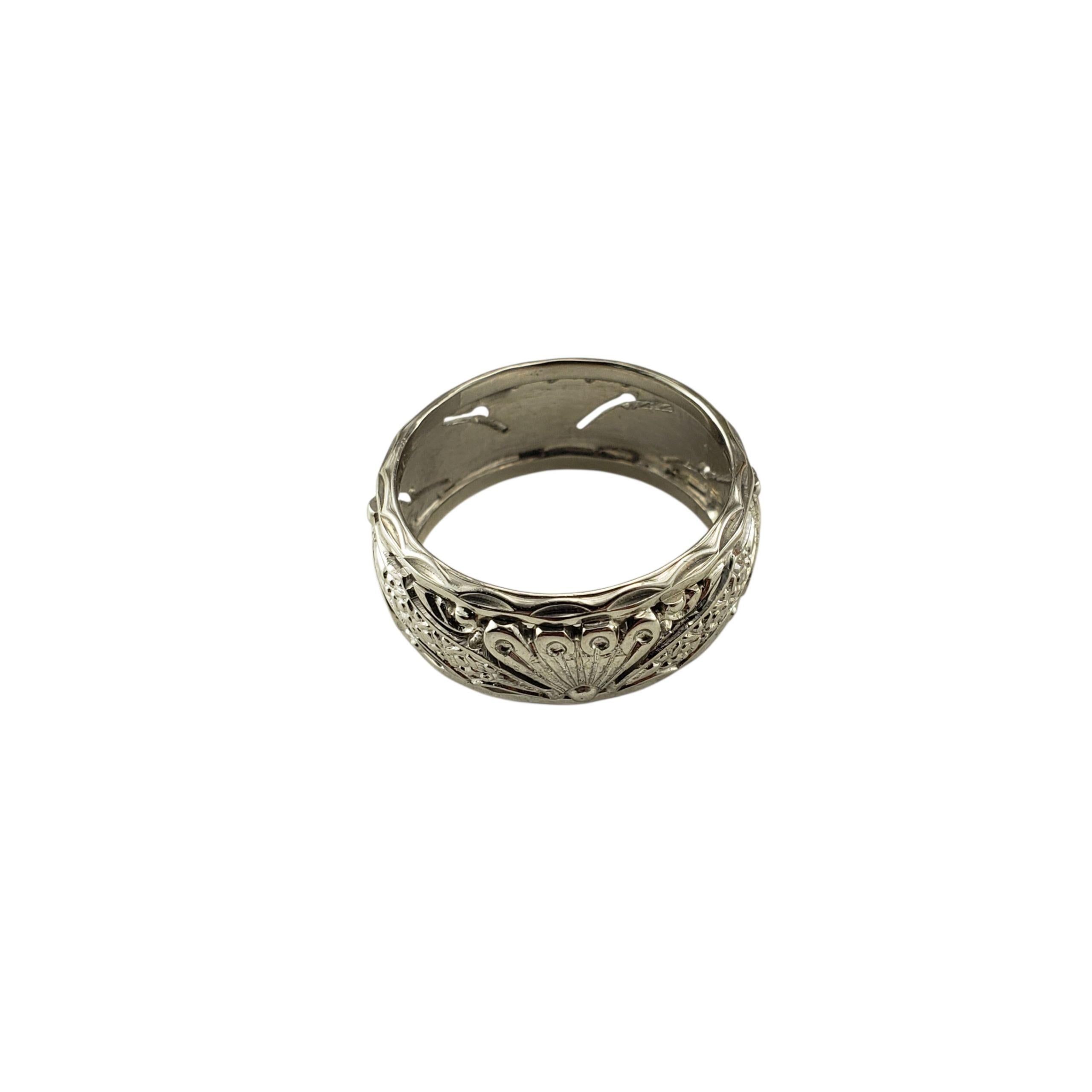 14 Karat White Gold Filigree Band Ring Size 6.5

A beautifully detailed design in 14K white gold, this wide band ring features intricate openwork filigree with delicate scroll motifs. The raised relief patterns create dimension and texture, giving