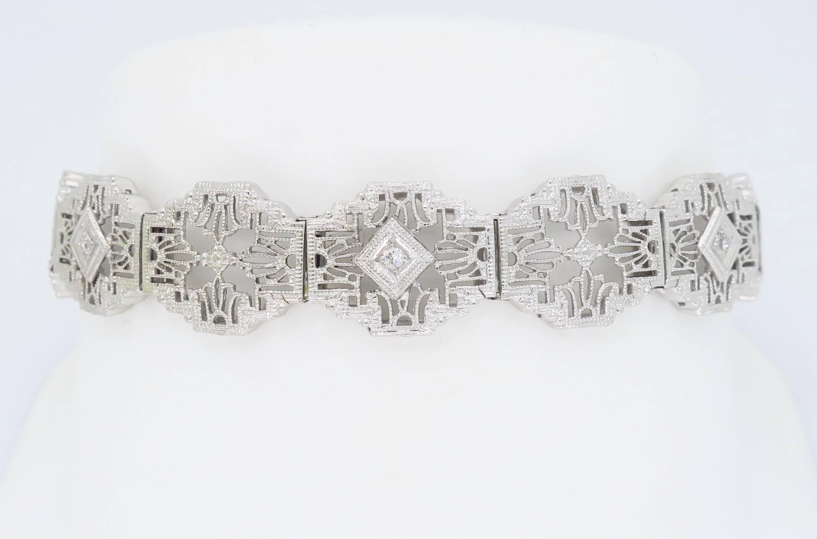 Stunning White Gold Filigree Bracelet with Ornate Detail and Diamond Accents

Gemstone: Three Diamond Accents
Metal: 14K White Gold
Marked/Tested: Stamped “14K” 
Weight: 9.7 Grams
Bracelet Length: 7” 