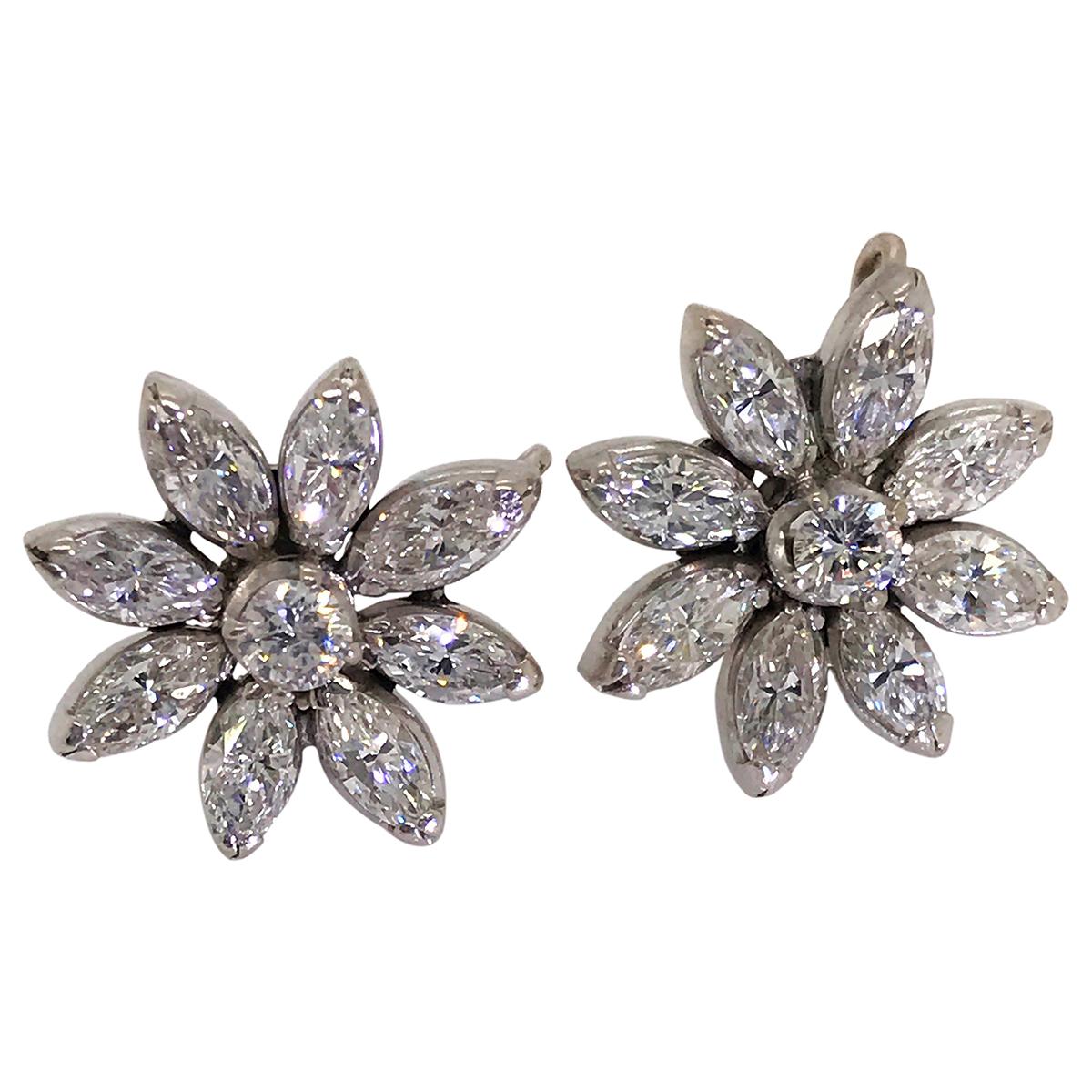 Pretty flower stud earrings each set with 8 marquise cut diamonds forming the flower petals with a central round cut diamond. The total diamond weight for both earrings is 2.10cts mounted in 14k white gold. The back of the earring has a small hook
