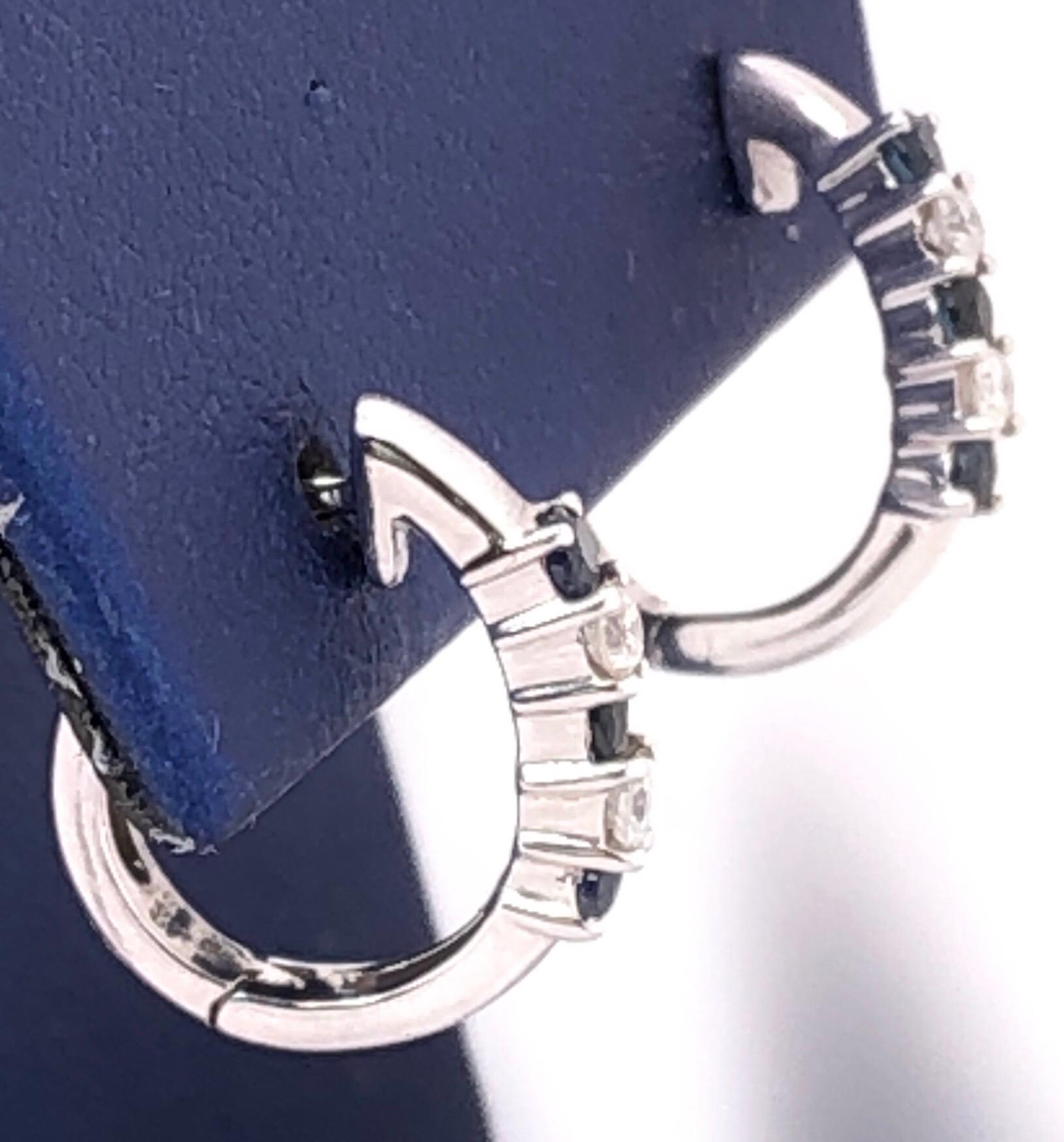 14 Karat White Gold Free Style Earrings with Sapphire and Round Diamonds 0.20 TDW
2.29 grams totaL weight. 14.4 mm