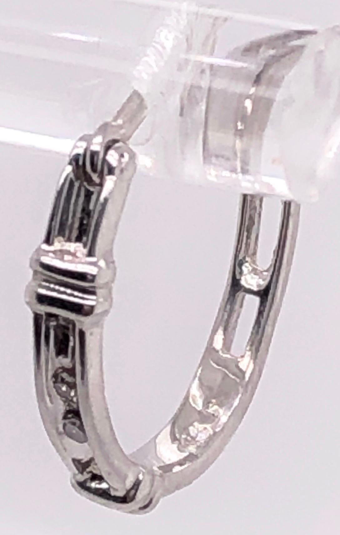 14 Karat White Gold Freestyle Earrings with Diamonds.
0.04 total diamond weight.
1.65 grams total weight.