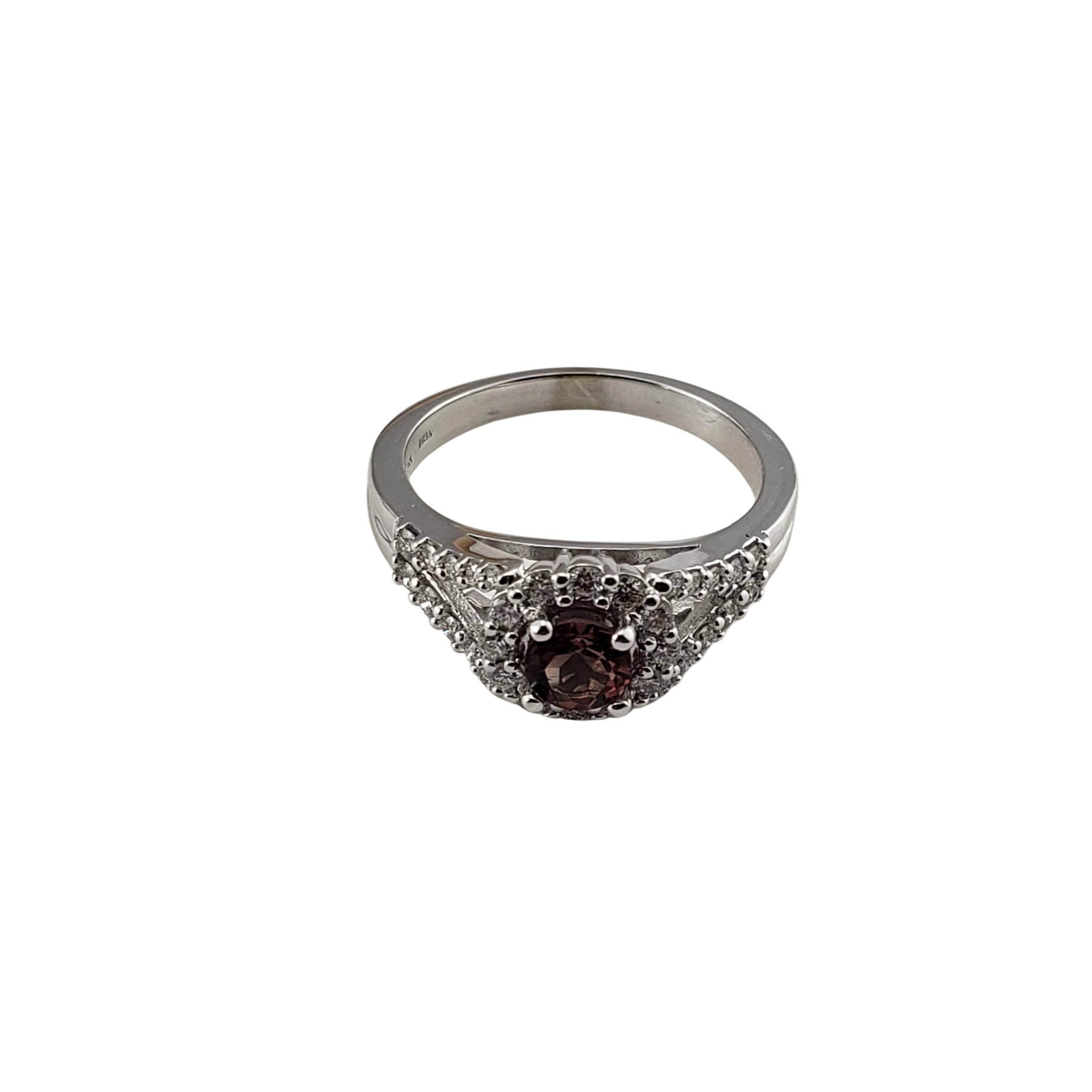14 Karat White Gold Garnet and Diamond Ring Size 8.25 GAI Certified-

This lovely ring features one round pink garnet (5 mm) and 32 round brilliant cut diamonds set in classic 14K white gold.  
Shank: 3 mm.

Garnet weight:  .66 ct.

Total diamond