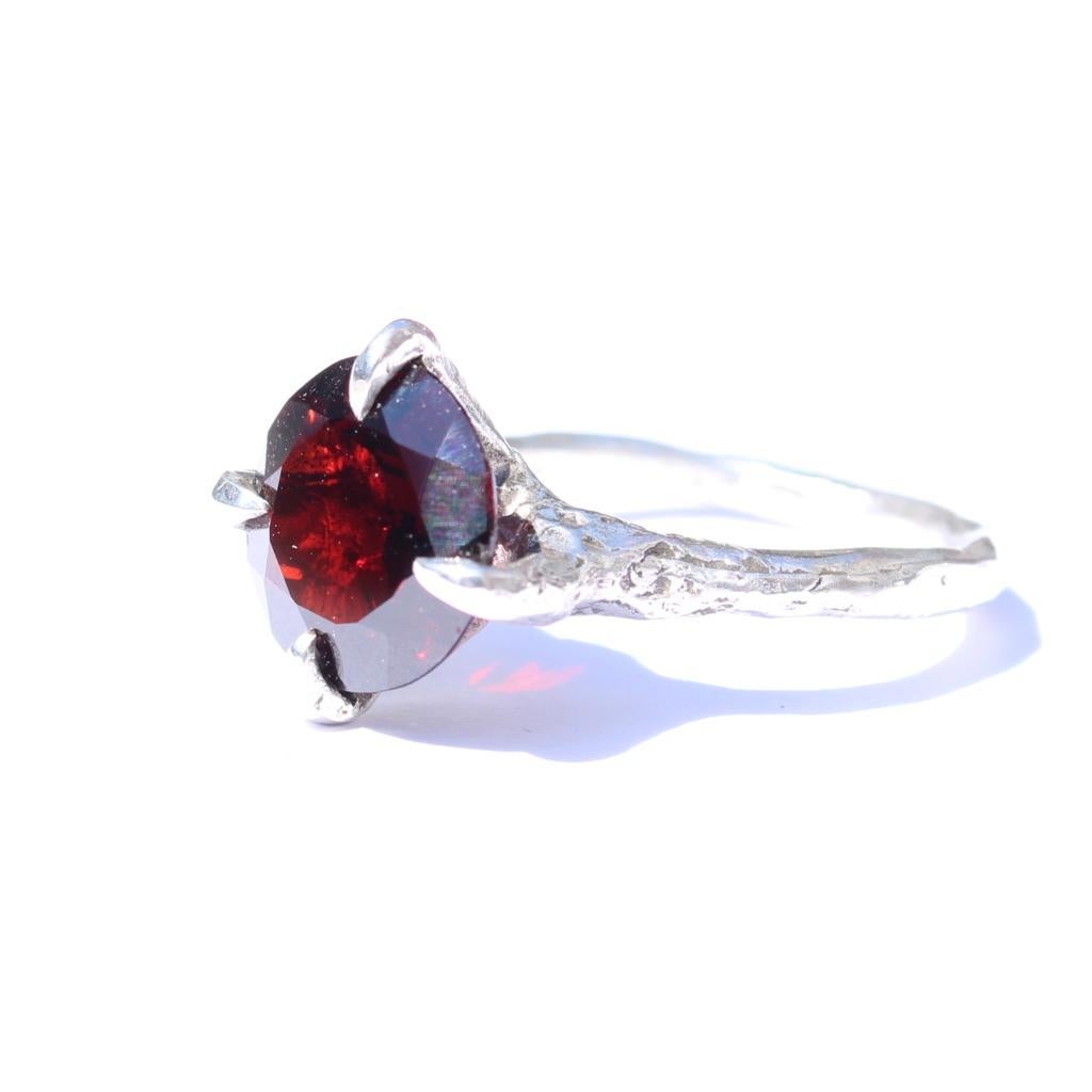 Handmade 10mm garnet set in 14k white gold. This is a stunning statement ring with a deep red garnet is set with pointed claw-like prongs. 

Size 5.5
This ring can be made to order in your size.