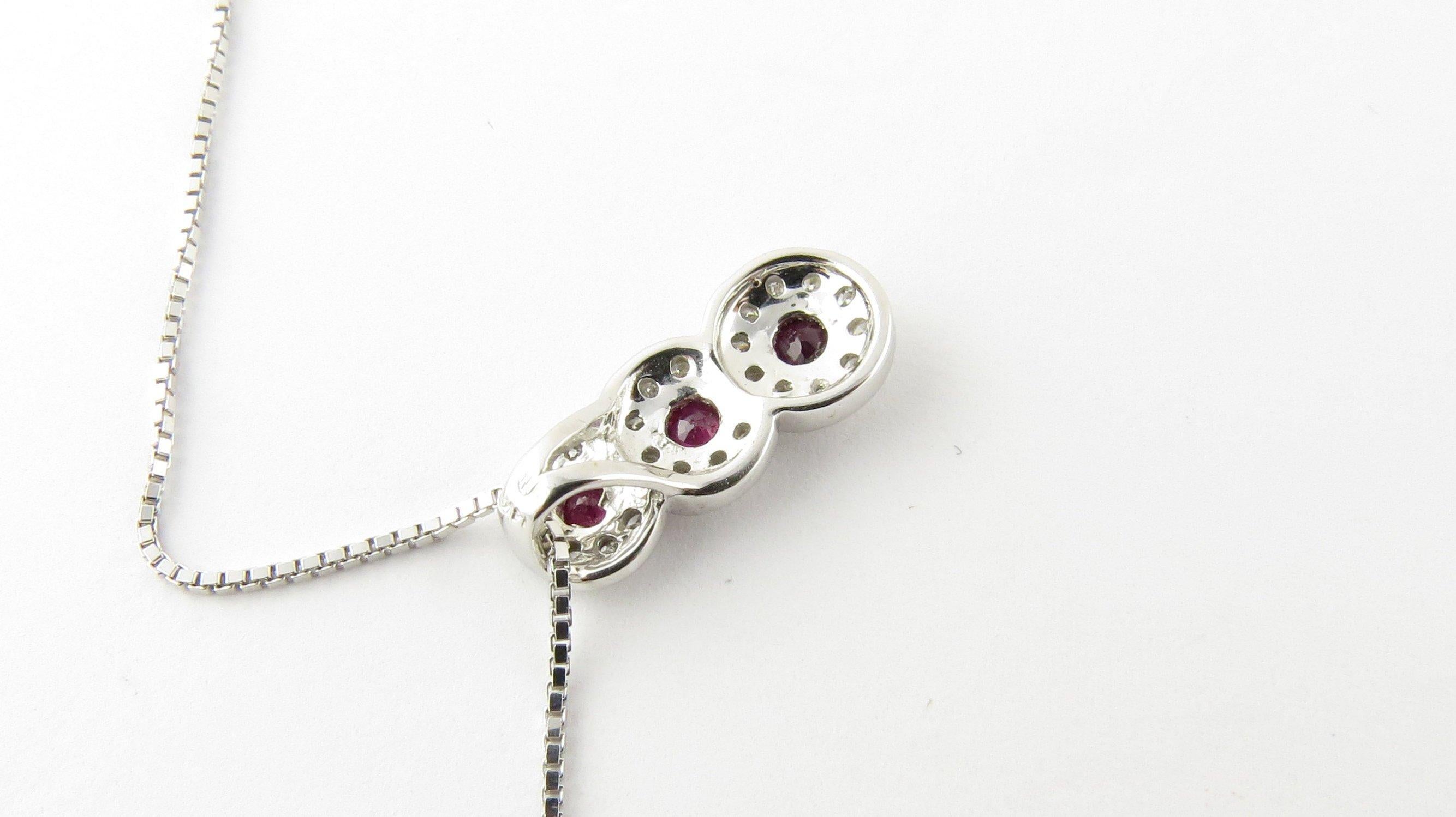 Vintage 14 Karat White Gold Genuine Ruby and Diamond Pendant Necklace- This lovely pendant features three round genuine rubies (3 mm each) surrounded by 24 round brilliant cut diamonds suspended from a classic 18