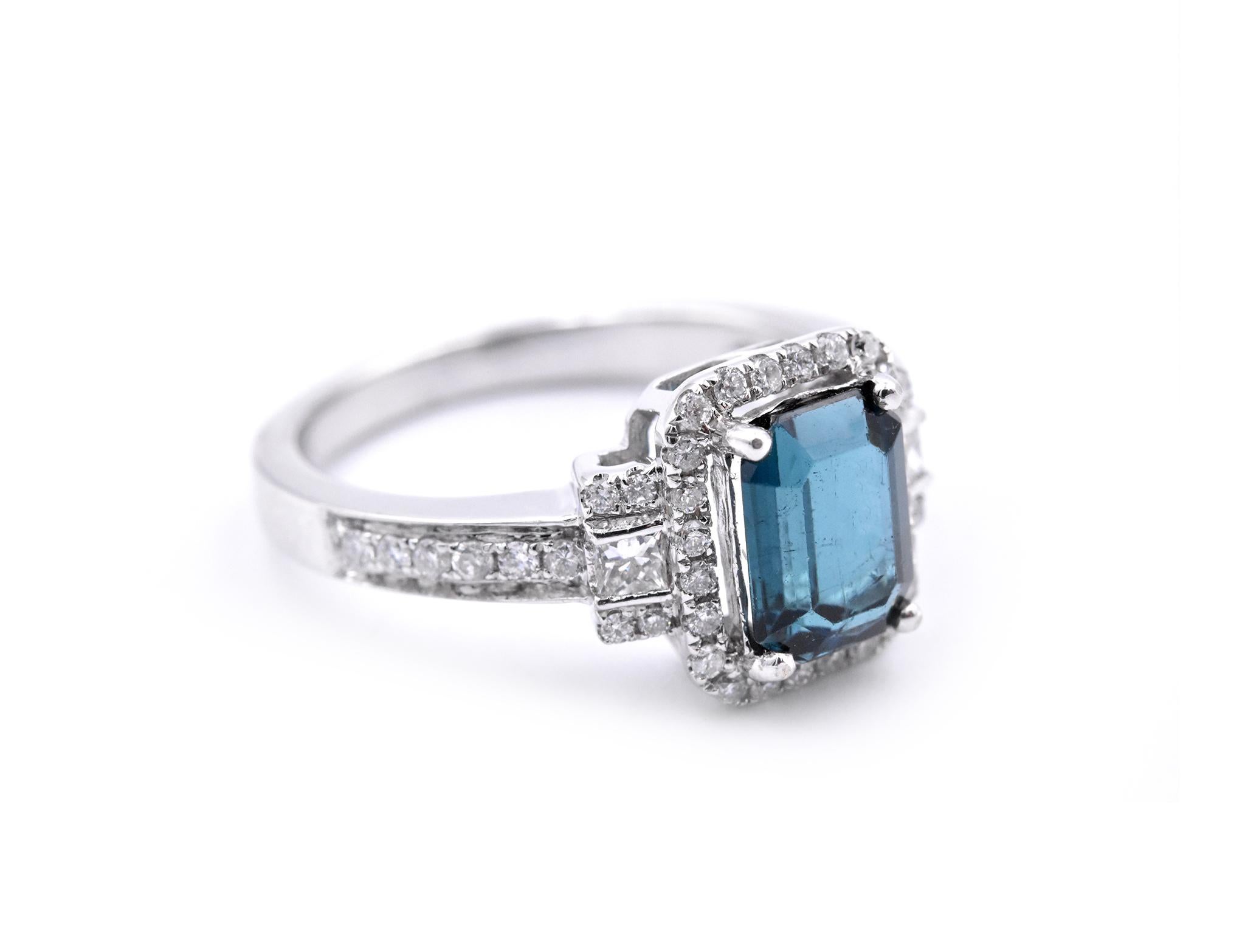 Designer: custom design
Material: 14k white gold
Gemstones: Green Blue Tourmaline = 1.52ct Emerald Cut 
Certification: AGI 25347
Diamonds: 48 round brilliant cuts = .53cttw
Color: F
Clarity: VS2-SI
Ring Size: 7.5 (please allow two additional