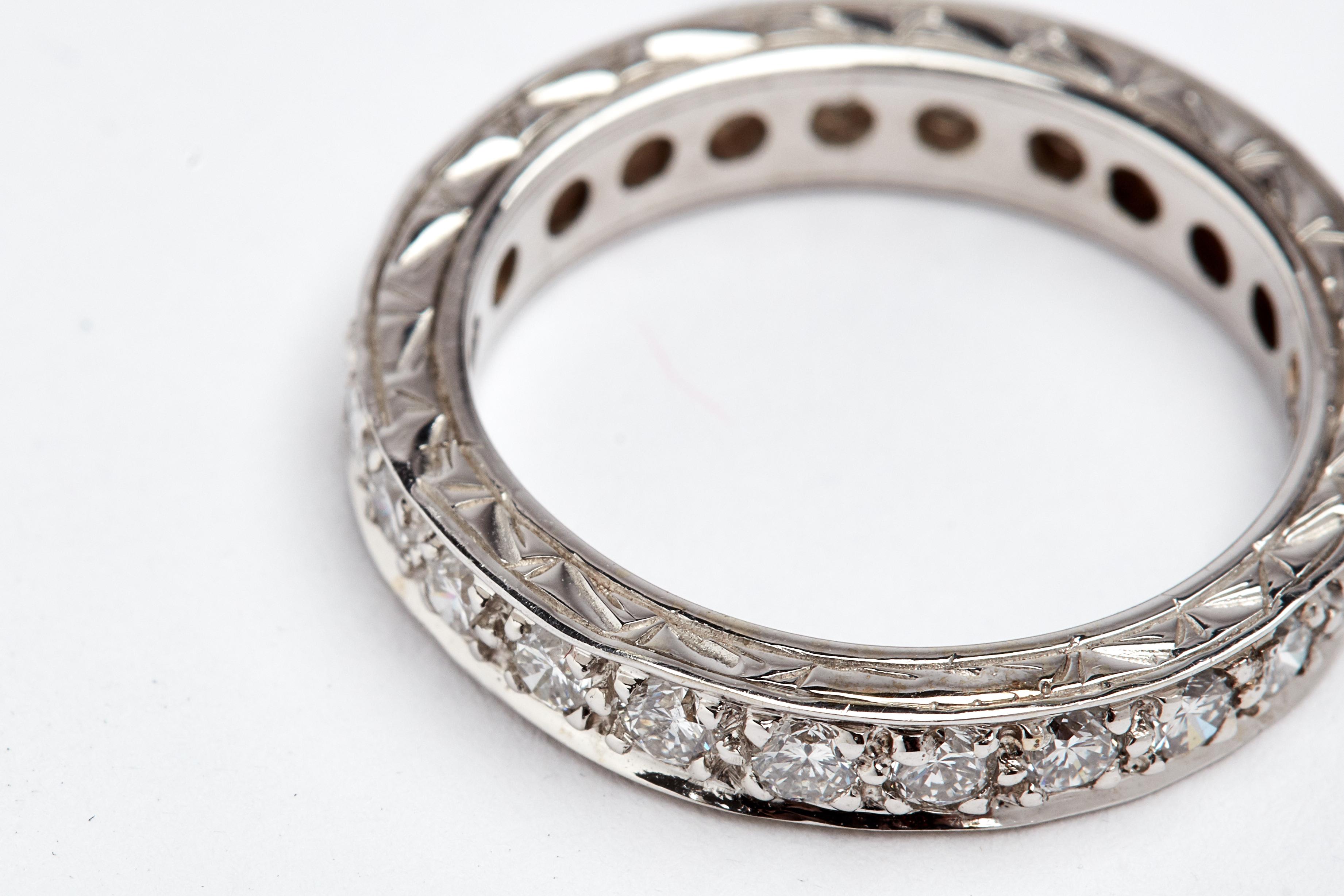 14K White gold hand carved channel set eternity band. Aprox 1.20 carats of round white diamonds. size 6.5