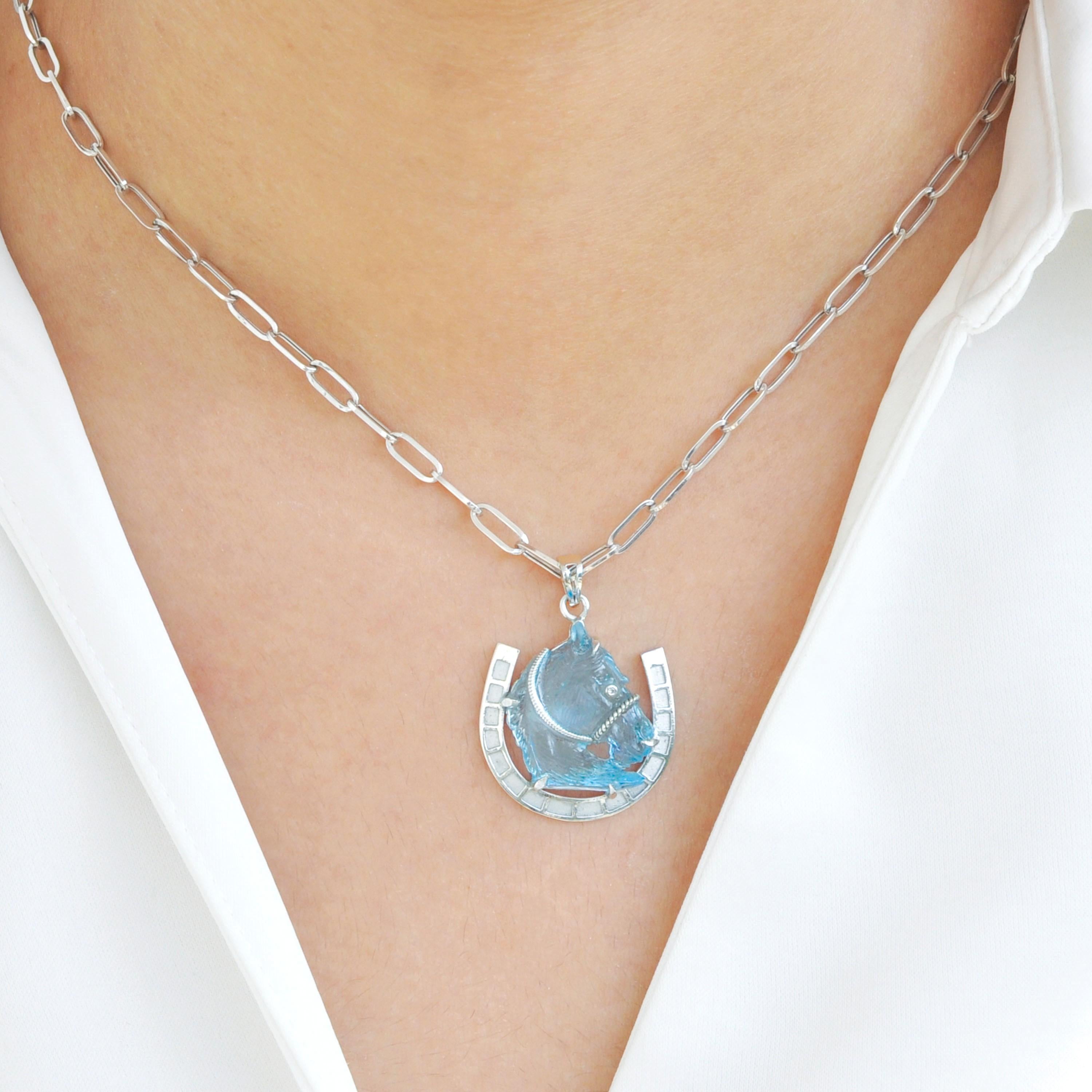 This exceptional 14 Karat White Gold pendant is a striking combination of artistic craftsmanship and timeless elegance, designed to captivate lovers of both fine jewelry and equestrian beauty. The centerpiece of this pendant is a hand-carved Swiss