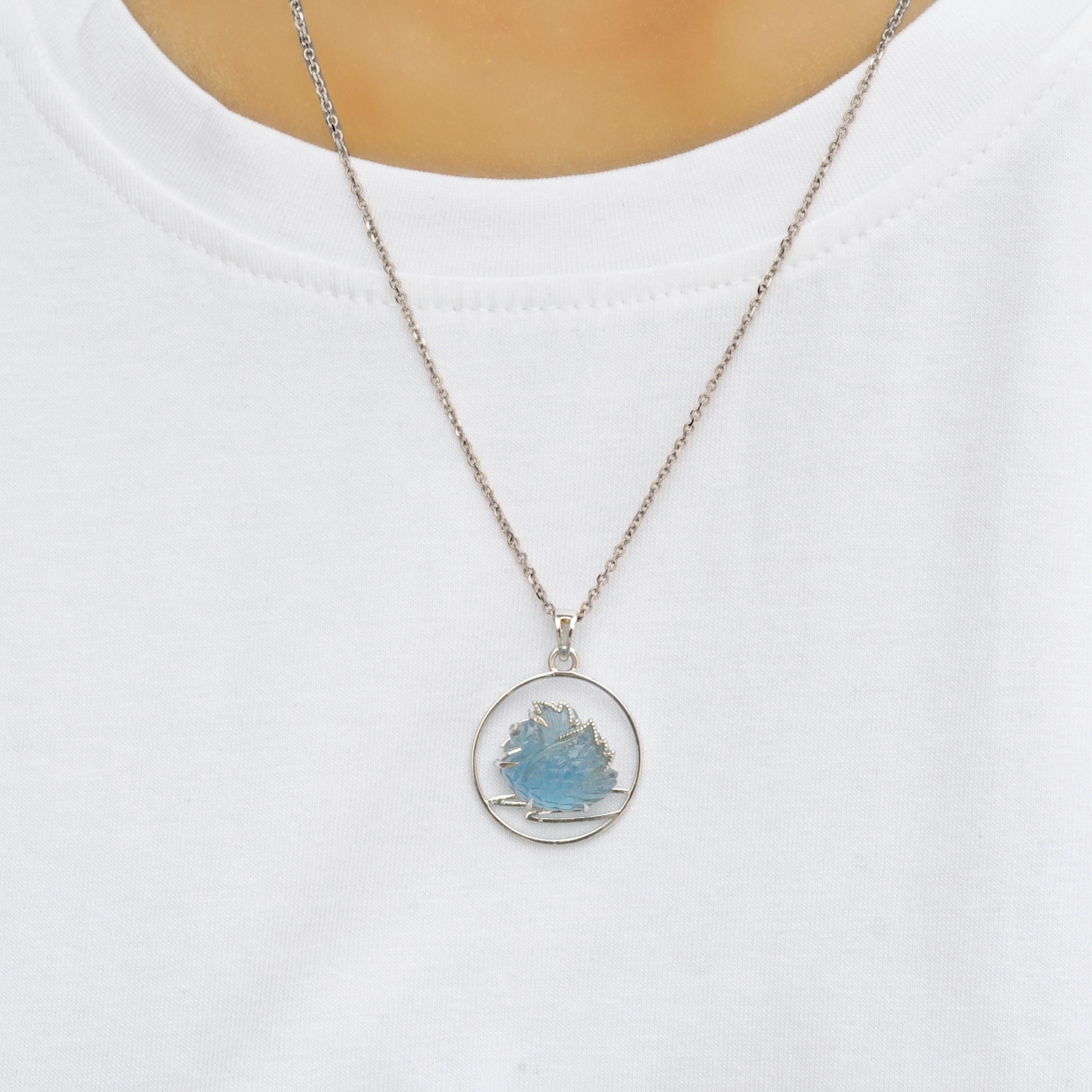 This exquisite 14 Karat White Gold pendant necklace is a masterpiece of craftsmanship and design, inspired by the serene elegance of a swan gliding across a tranquil lake. At its heart lies a stunning Swiss Blue Topaz gemstone weighing 10.70 carats,