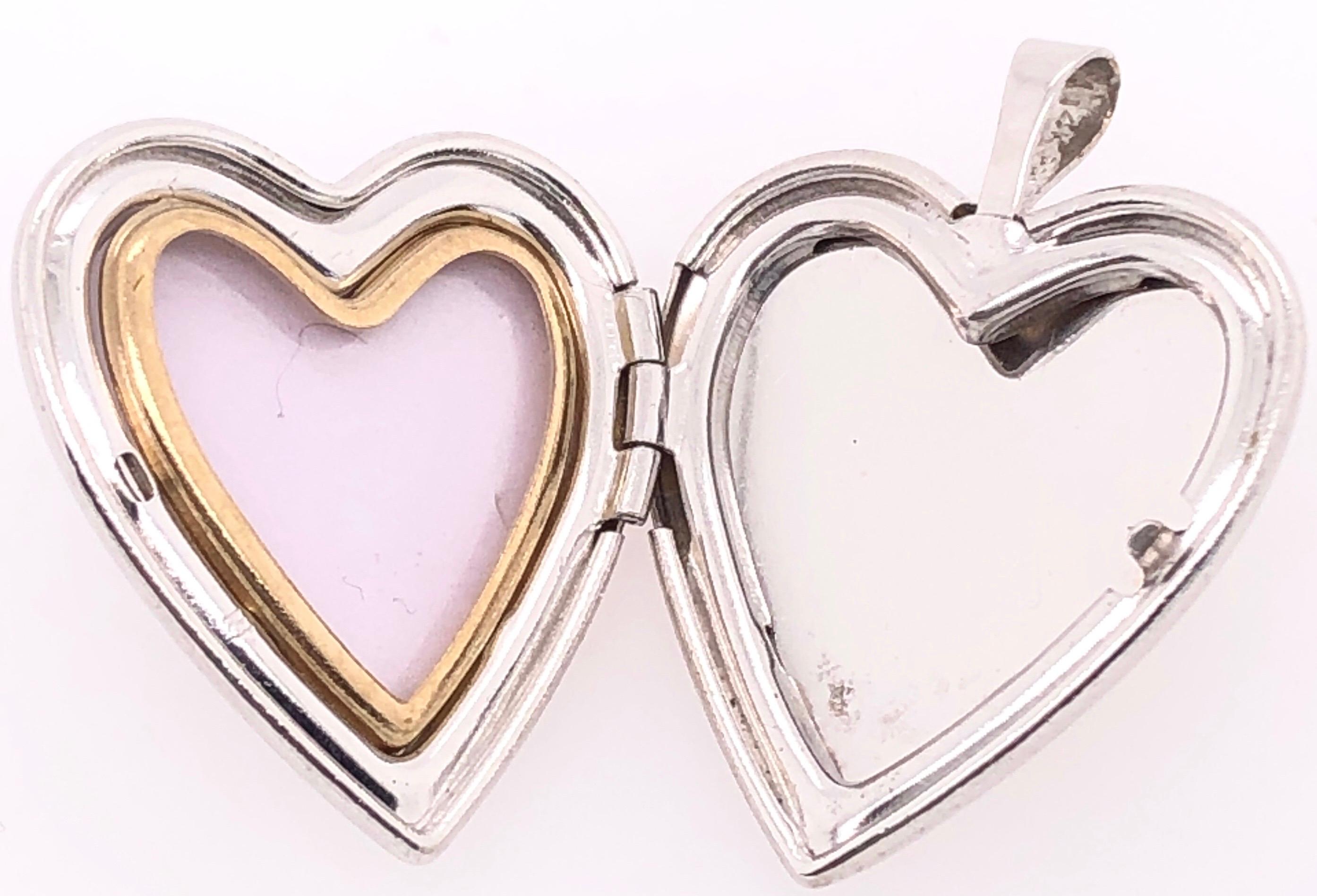 14 Karat White Gold Heart Locket Pendant with Diamonds 0.18 TDW.
5 grams total weight.