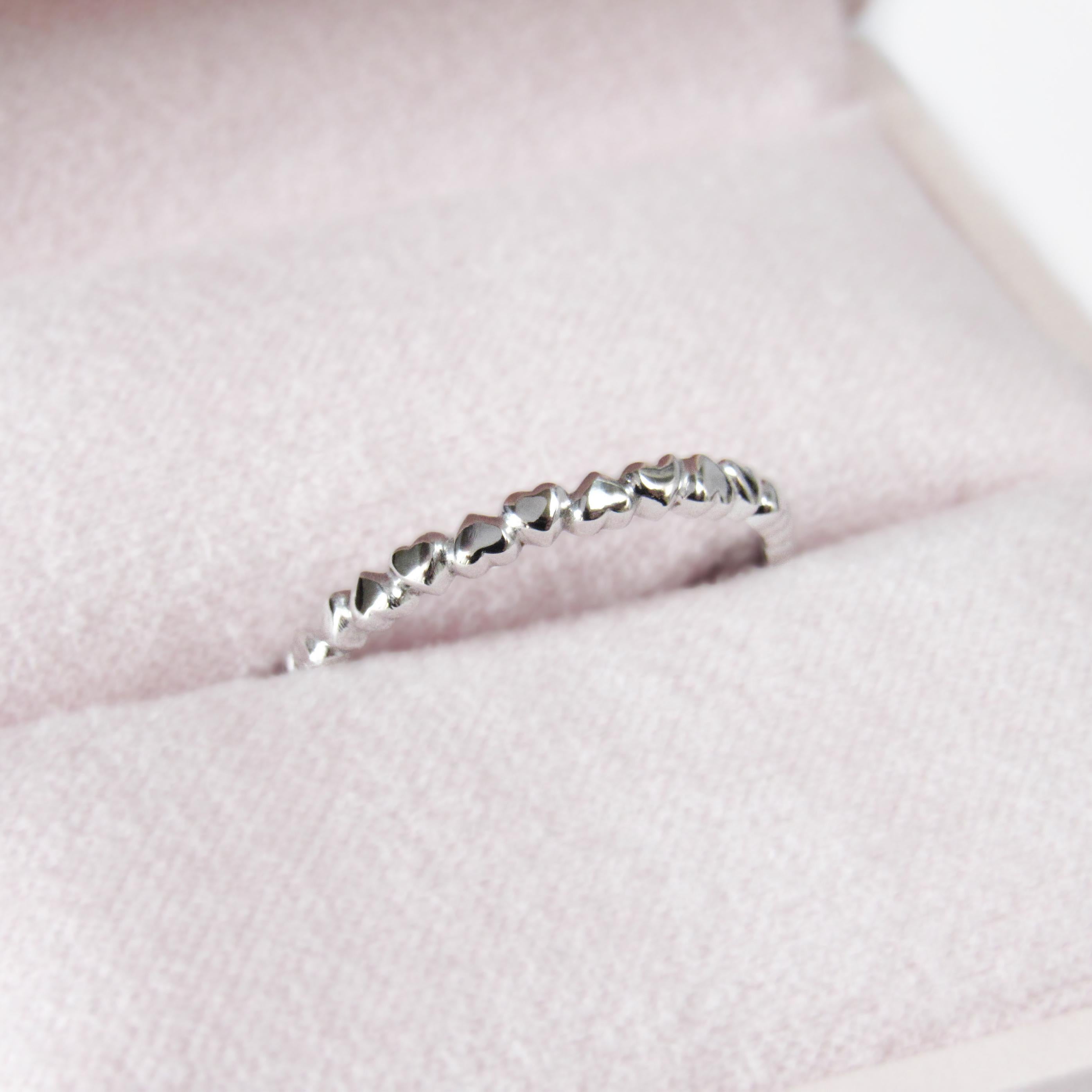 MADE TO ORDER *Please note that we take 20 business days to create your jewel before its ready to ship. Be sure to specify your ring size number.

This 14 karat white gold ring has been designed with hearts interlaced throughout the whole ring.