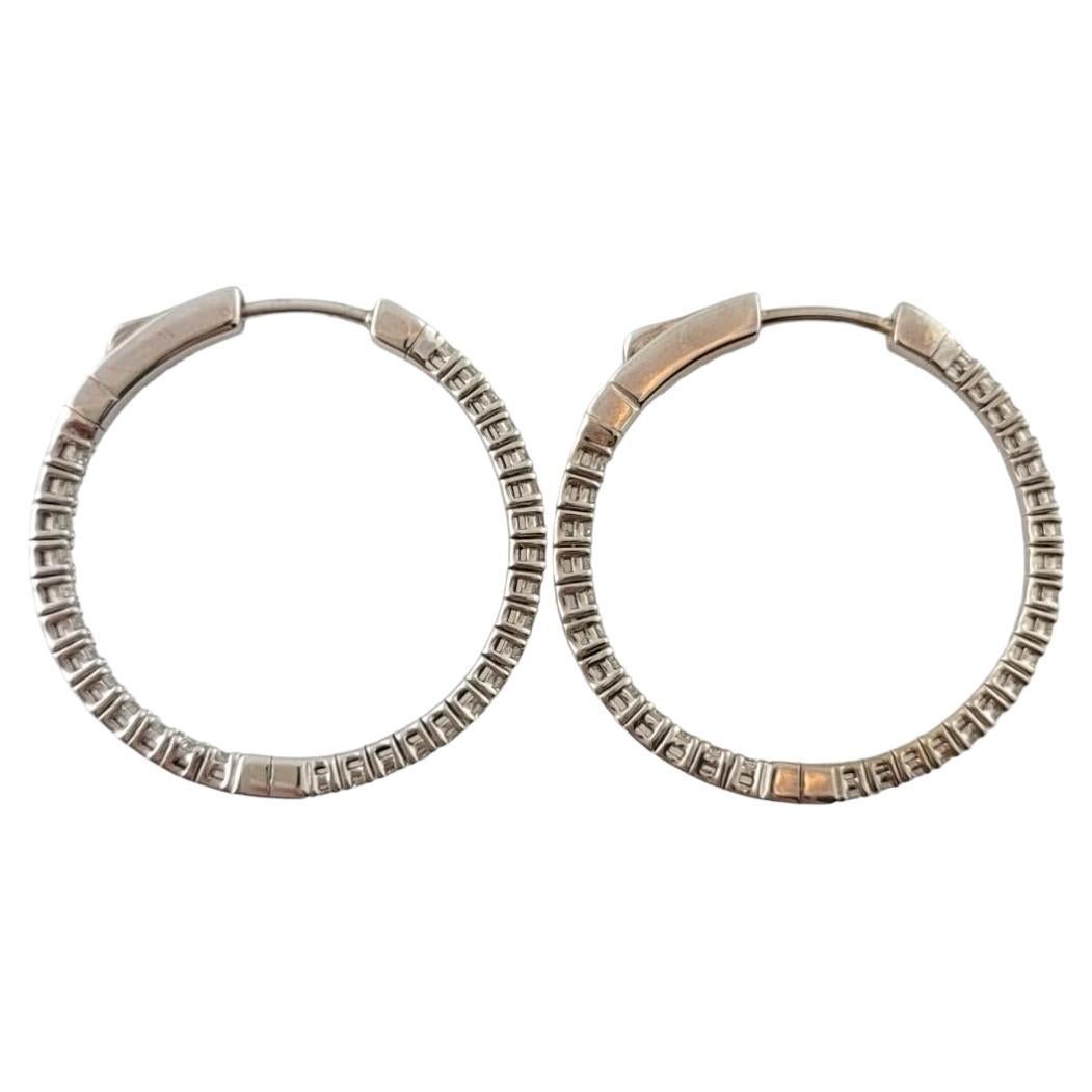 These sparkling hinged hoop earrings each feature 30 round brilliant cut diamonds set in classic 14K white gold.

Approximate total diamond weight:   1.20 ct.

Diamond color: J-K

Diamond clarity: VS1

Size:  28 mm x 2 mm

Weight:    3.8 dwt. /  6.0