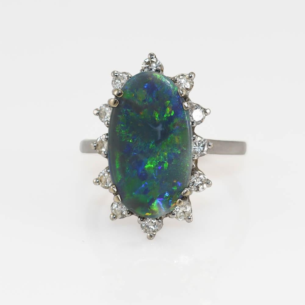 Oval Cut 14 Karat White Gold Ladies Australian Black Opal and Diamond Cocktail Ring For Sale