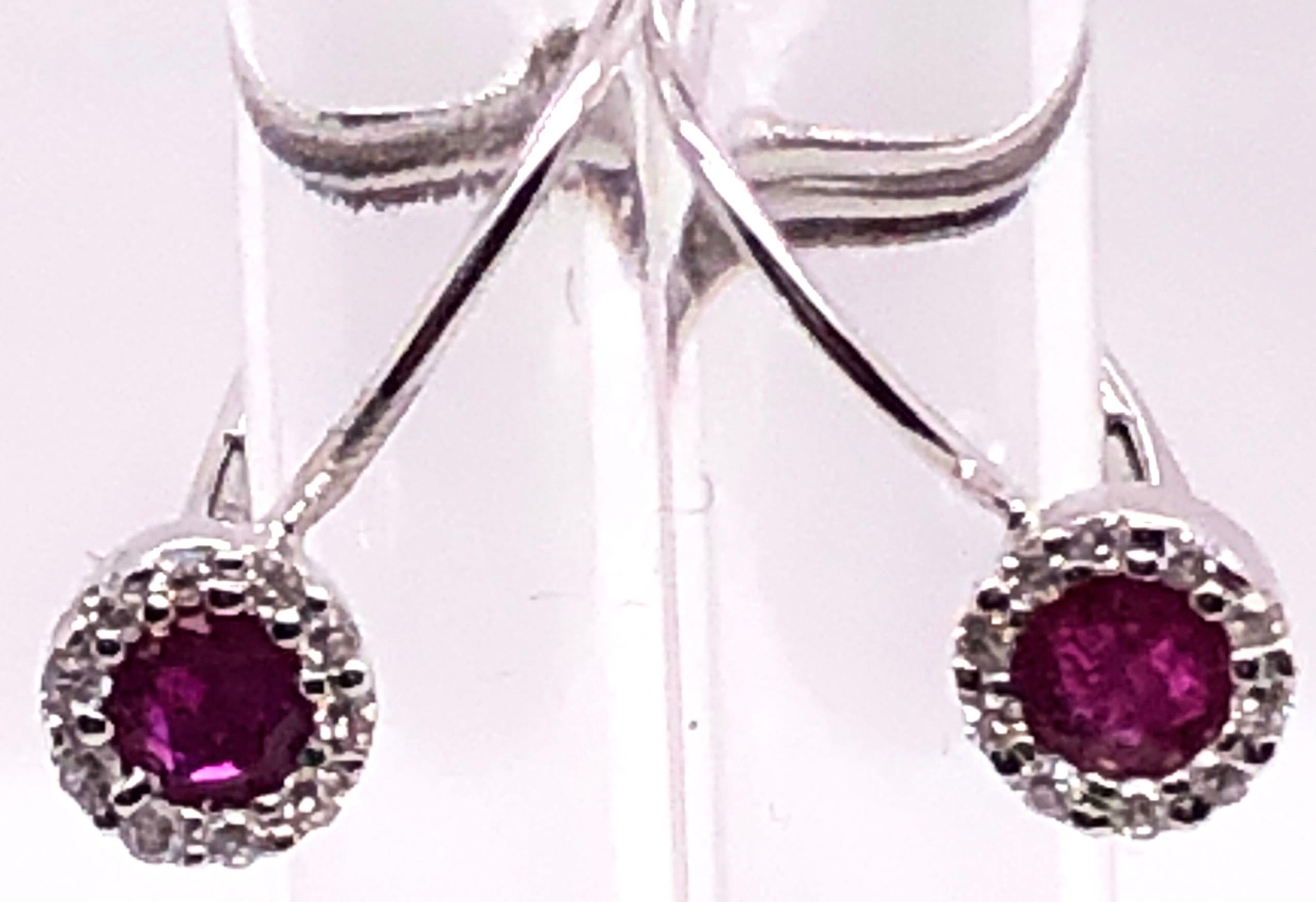 14 Karat White Gold Latch Back Ruby Earrings with Diamonds.
0.20 total diamond weight.
1.08 gram total weight.