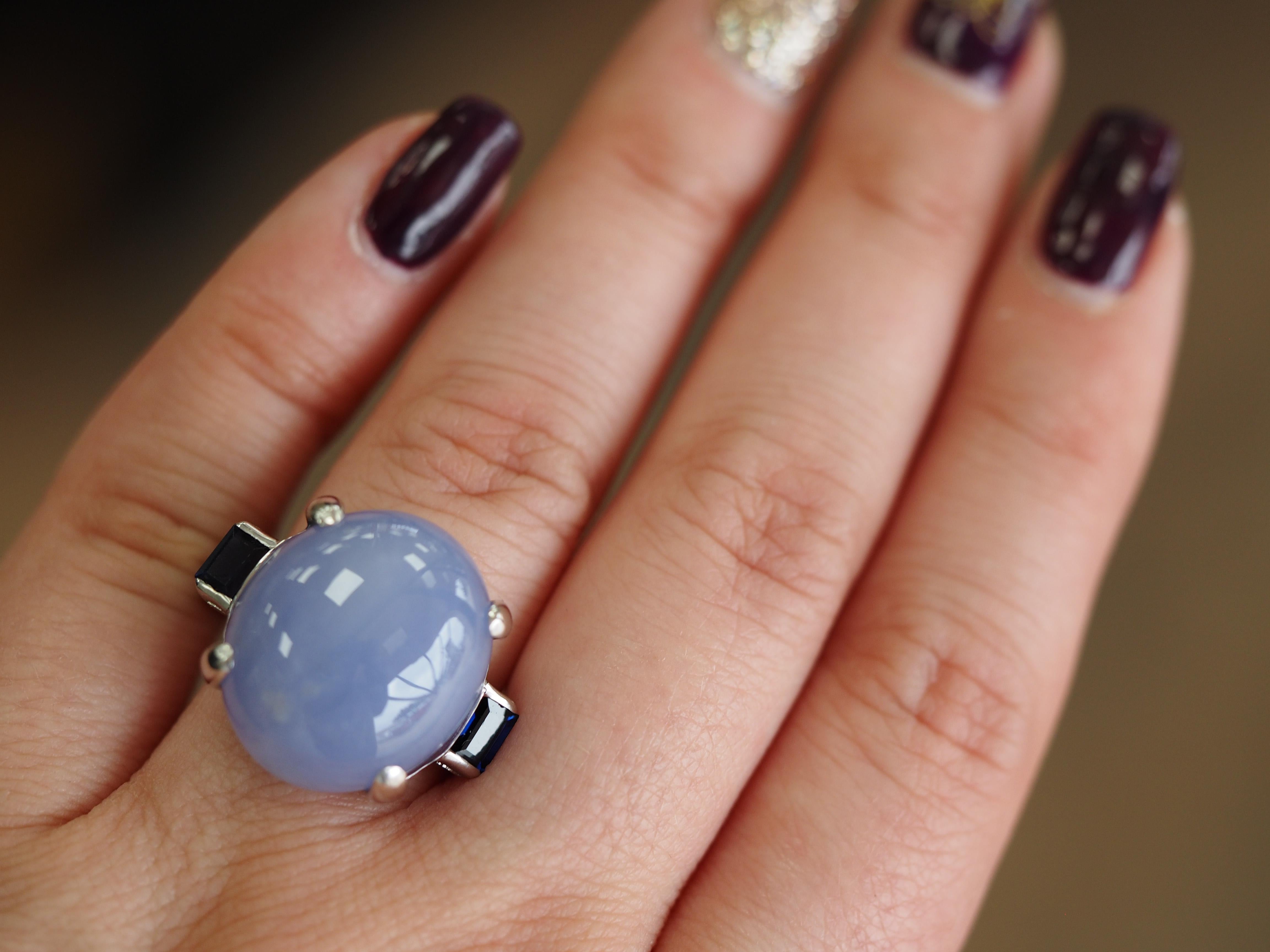 14K White Gold Lavender Jade & Sapphire Cocktail Ring. The stone is set into a 14 karat white gold four prong setting, the two side sapphires are set with delicate prongs. Ring weighs 10.3 grams. Finger size 8.5, this ring is sizable.

Earring
