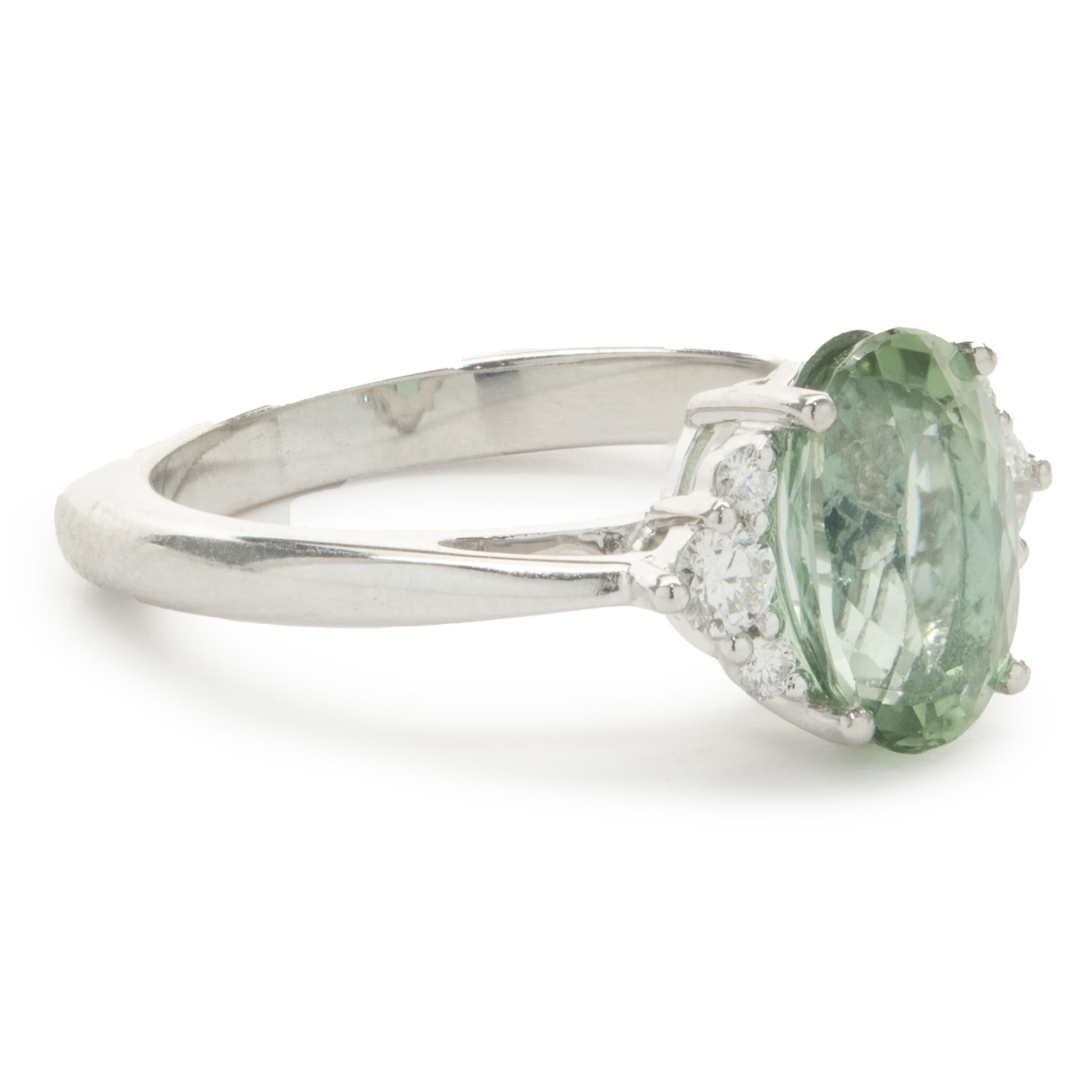 Designer: custom
Material: 14K white gold
Diamond: 6 round brilliant cut = .38cttw
Color: G
Clarity: VS2
Tourmaline: 1 oval cut = 2.56ct
Color: Mint Green
Clarity: AA
Dimensions: ring top measures 10.50mm wide
Ring Size: 7.5 (complimentary sizing