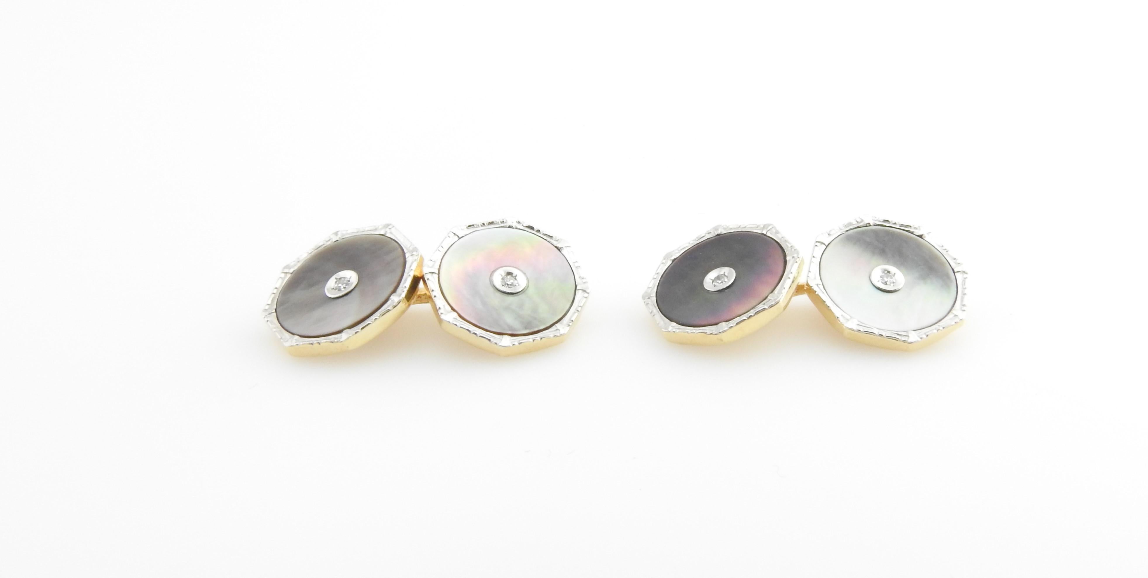 Vintage 14 Karat White Gold Mother of Pearl and Diamond Cuff Links

These lovely cufflinks each feature mother of pearl and two round single cut diamonds set in beautifully detailed 14K white gold.

Approximate total diamond weight: .04 ct.

Diamond