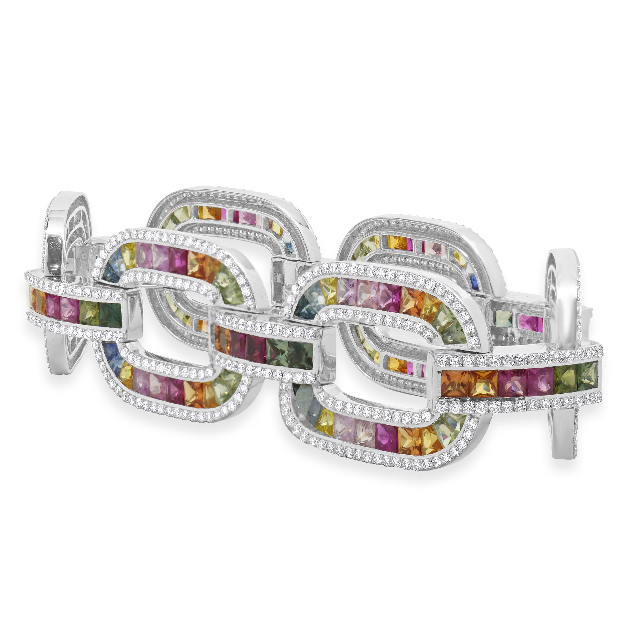 Designer: custom
Material: 14K white gold
Diamond: 572 round brilliant cut = 5.60cttw
Color: G
Clarity: VS-SI1
Multi-Colored Sapphire: 150 round cut = 28.72cttw
Weight: 41.68 grams
Dimensions: bracelet will fit up to a 8-inch wrist
