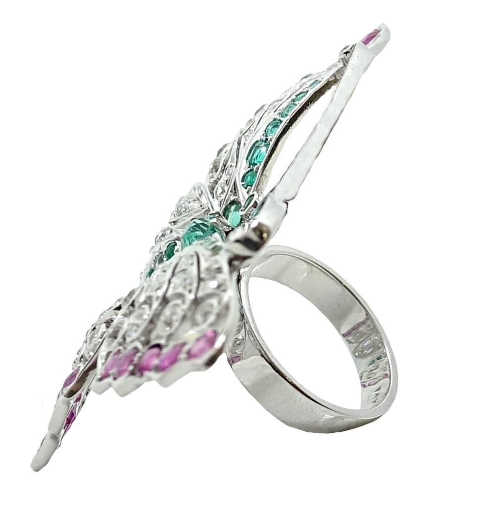 This Eye Catching 14K White Gold Ring Has A Gorgeous Statement Butterfly On Top. Within The Butter Fly Are Sparkling Pink Toned Rubies Weighing A Total Carat Weight 3.50 Carats. Emerald Are Set In The Center Of This Piece And Weigh A Total Carat