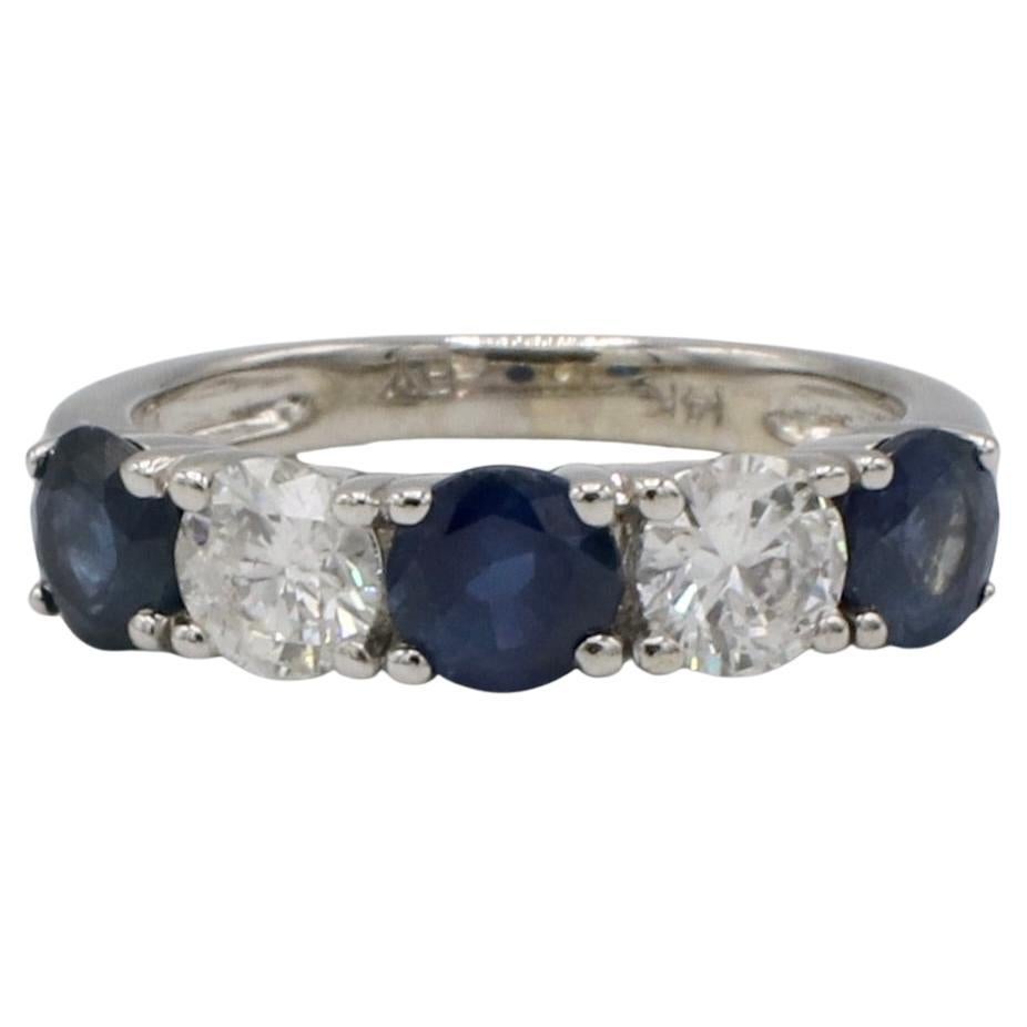 14 Karat White Gold Natural Diamond & Blue Sapphire Half Band Wedding Ring 
Metal: 14k white gold
Weight: 3.79 grams
Diamonds: 2 round natural diamonds, approx. .90 CTW G-H SI
Size: 6 (US)
Height:  4mm
LTD 111181-5
