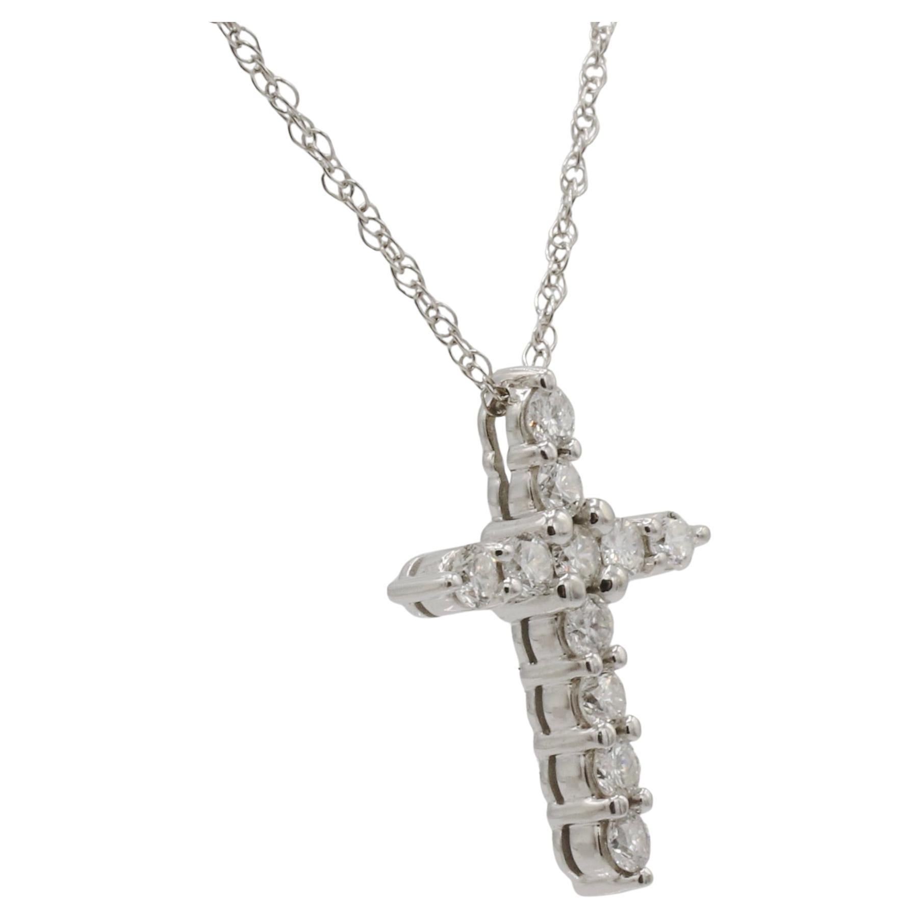 14 Karat White Gold Natural Diamond Cross Pendant Drop Necklace 
Metal: 14k white gold
Weight: 3.1 grams
Diamonds: 11 natural round brilliant cut diamonds approx. .80 CTW G-H VS
Pendant: 21.5 x 16mm
Length: 18 inches
AD F35000740