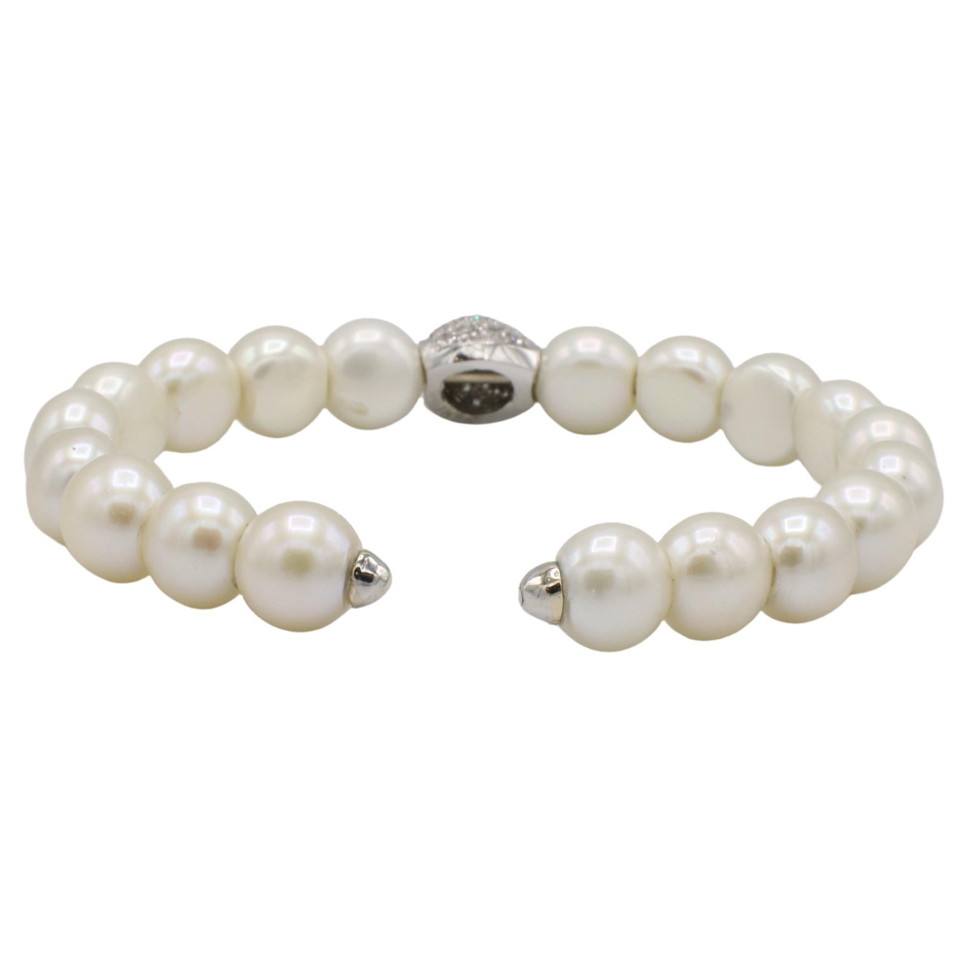14 Karat White Gold Natural Pave Diamond & Pearl Flex Bracelet 
Metal: 14k white gold
Weight: 24.18 grams
Size: Fits up to a 6.5 inch wrist
Width: 9.5mm
Pearls: 9.5mm
Diamonds: Approx. 0.20 CTW G-H VS round natural diamonds
RTD F35000130, RTD