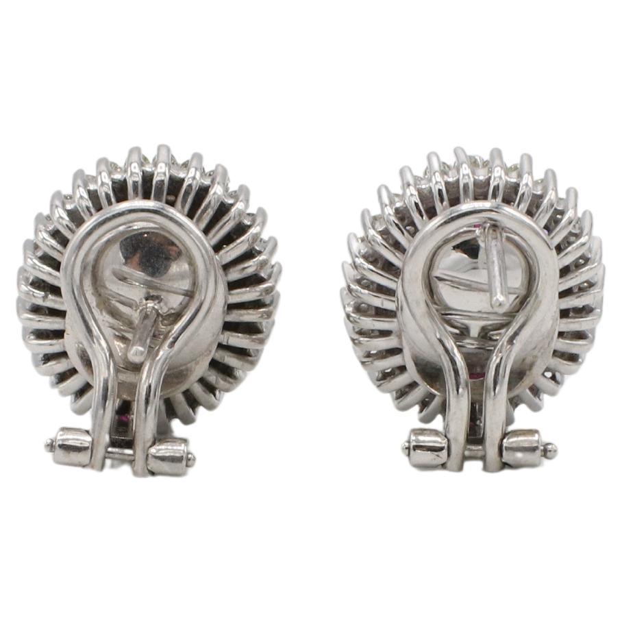 14 Karat White Gold Natural Ruby & Diamond Halo Earrings 
Metal: 14k white gold
Weight: 10.23 grams
Rubies: 9 x 7mm each
Diamonds: Approx. 1.00 CTW G-H VS round natural diamonds
Dimensions: 14 x 16mm
Backs: Lever backs with posts
