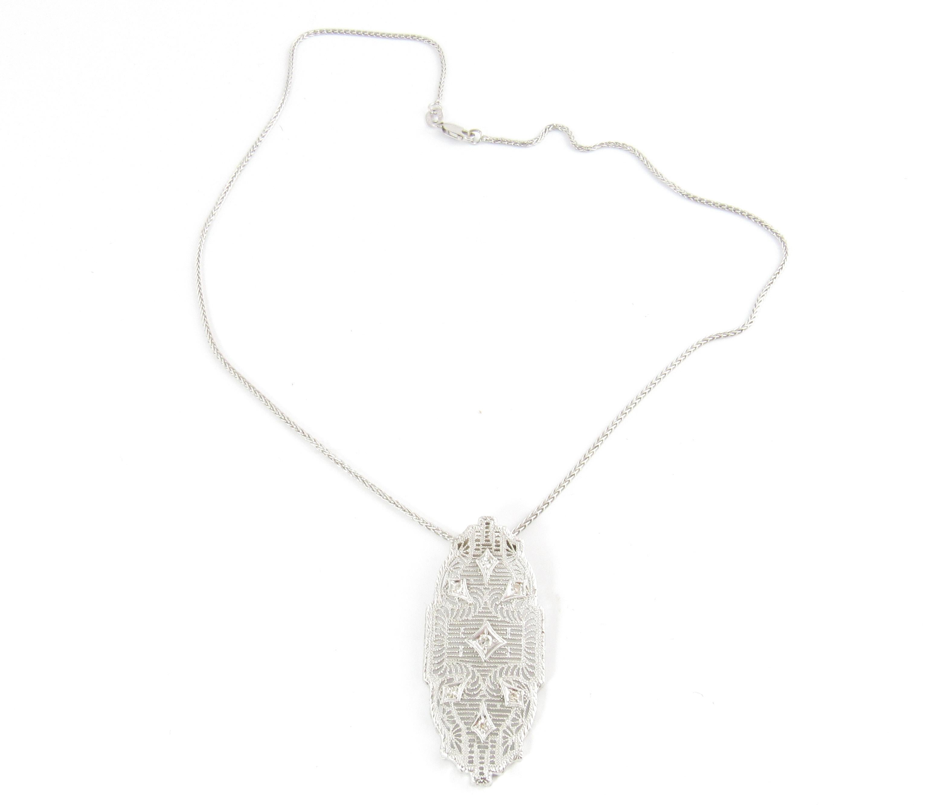 14 Karat White Gold Necklace and Diamond Pendant-

This stunning pendant features seven single cut diamonds set in beautifully detailed white gold filigree on a 16 inch white gold chain. 

Approximate total diamond weight: .15 ct.

Diamond clarity: