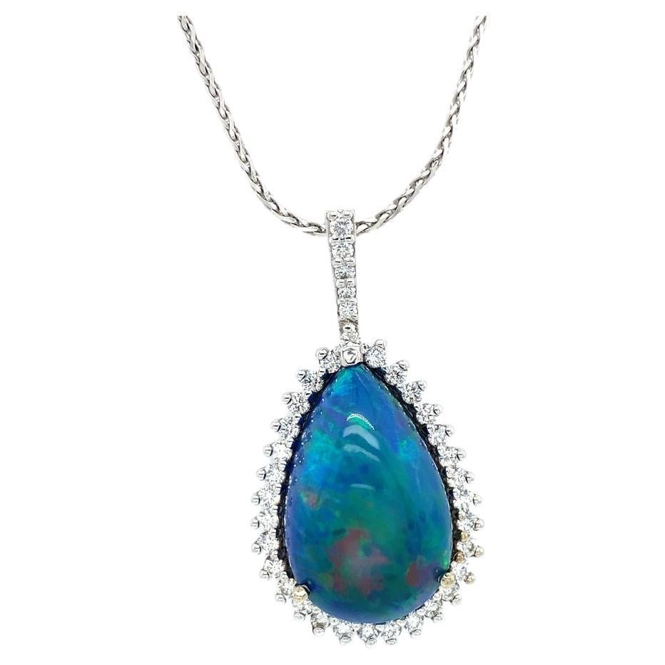 This elegant opal pendant is custom made by our expert jewelers. The blue opal is 16.74ct and has been smoked treated to give its brilliant color and fire. There is 0.80cttw of diamonds in the pendant. The chain is a 18 inch wheat chain in 14 karat