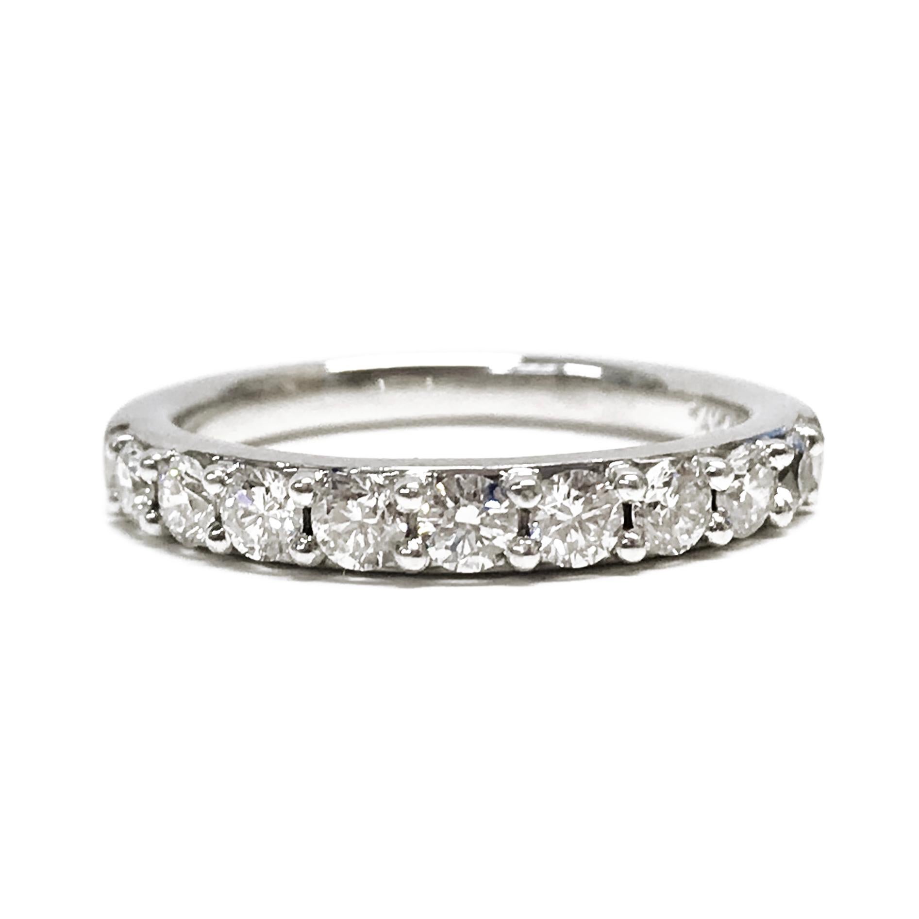 14 Karat White Gold Nine Diamond Ring. The classic band features nine round prong-set diamonds. Stamped on the inside of the band is the maker's mark RB 14K 585S. Diamonds are SI1-SI2 (G.I.A.) in clarity and G-H in color (G.I.A.). The diamonds