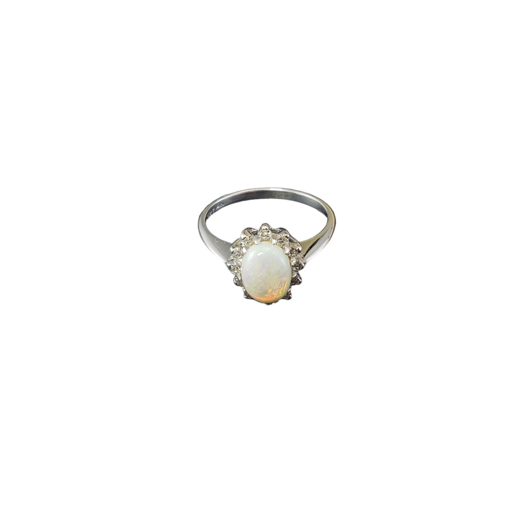 14 Karat White Gold Opal and Diamond Ring Size 6.25

This lovely ring features one oval opal gemstone (9 mm x 7 mm) surrounded by 12 round single cut diamonds8 set in classic 14K white gold. 

 Width: 11 mm.  Shank: 2 mm.

*Some small chips noted /