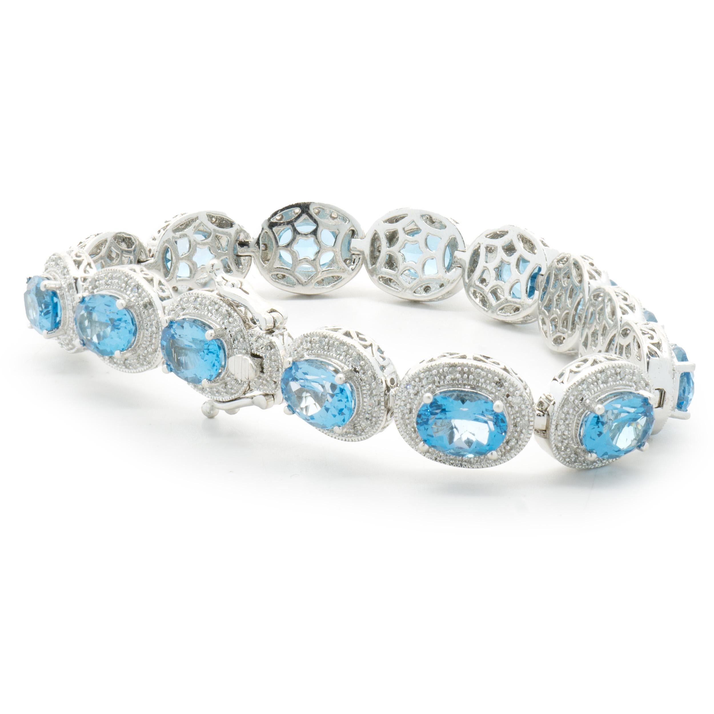 Designer: custom
Material: 14K white gold
Diamond: 201 round single cut = 1.00cttw
Color: H
Clarity: I1
Blue Topaz: 14 oval cut = 19.30cttw
Weight: 30.67 grams
Dimensions: bracelet will fit up to a 7-inch wrist