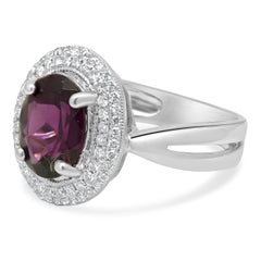14 Karat White Gold Oval Rhodolite Garnet and Round Diamond Halo Ring
