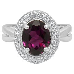14 Karat White Gold Oval Rhodolite Garnet and Round Diamond Halo Ring