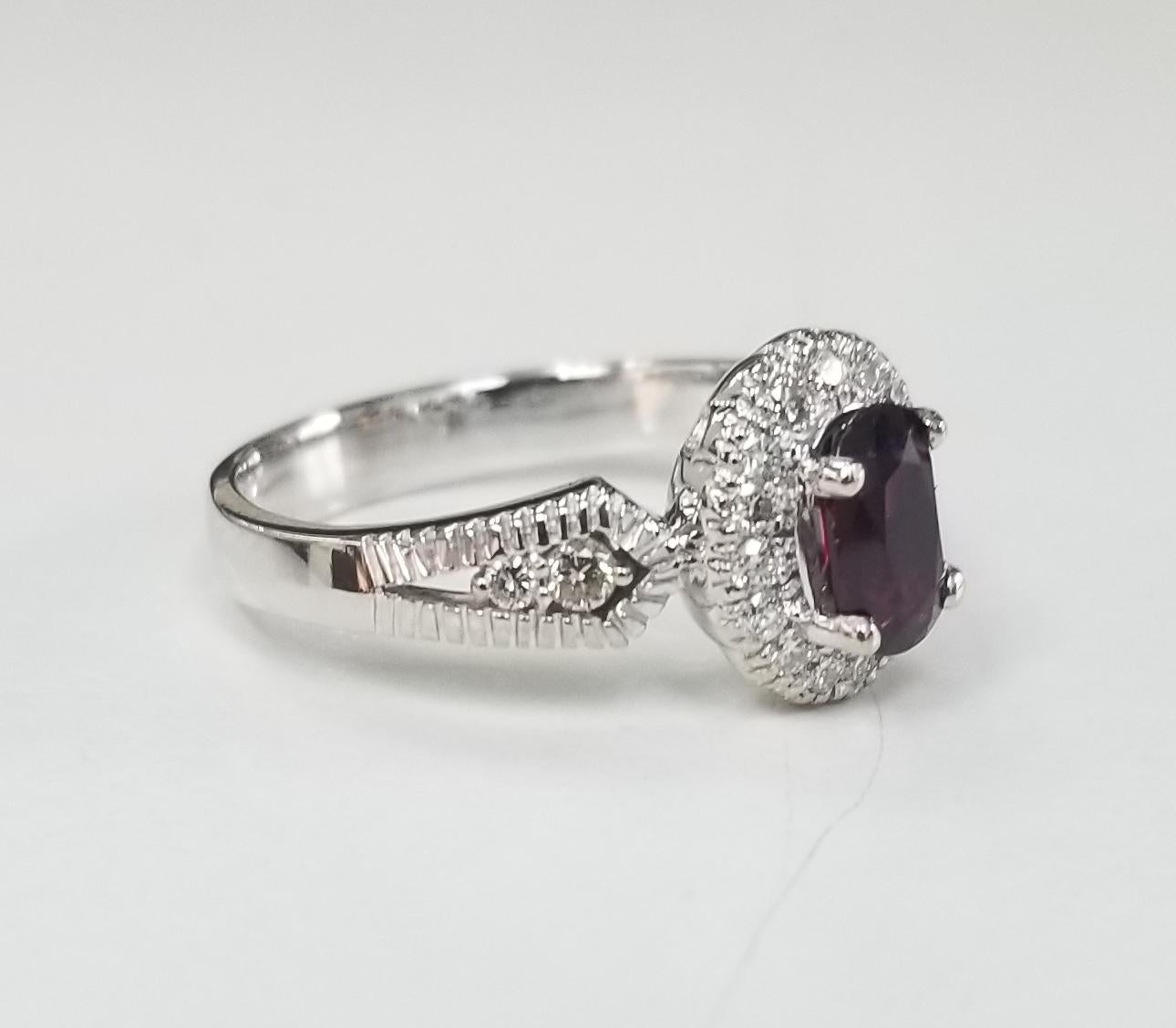 Contemporary 14 Karat White Gold Oval Ruby and Diamond Halo Ring For Sale